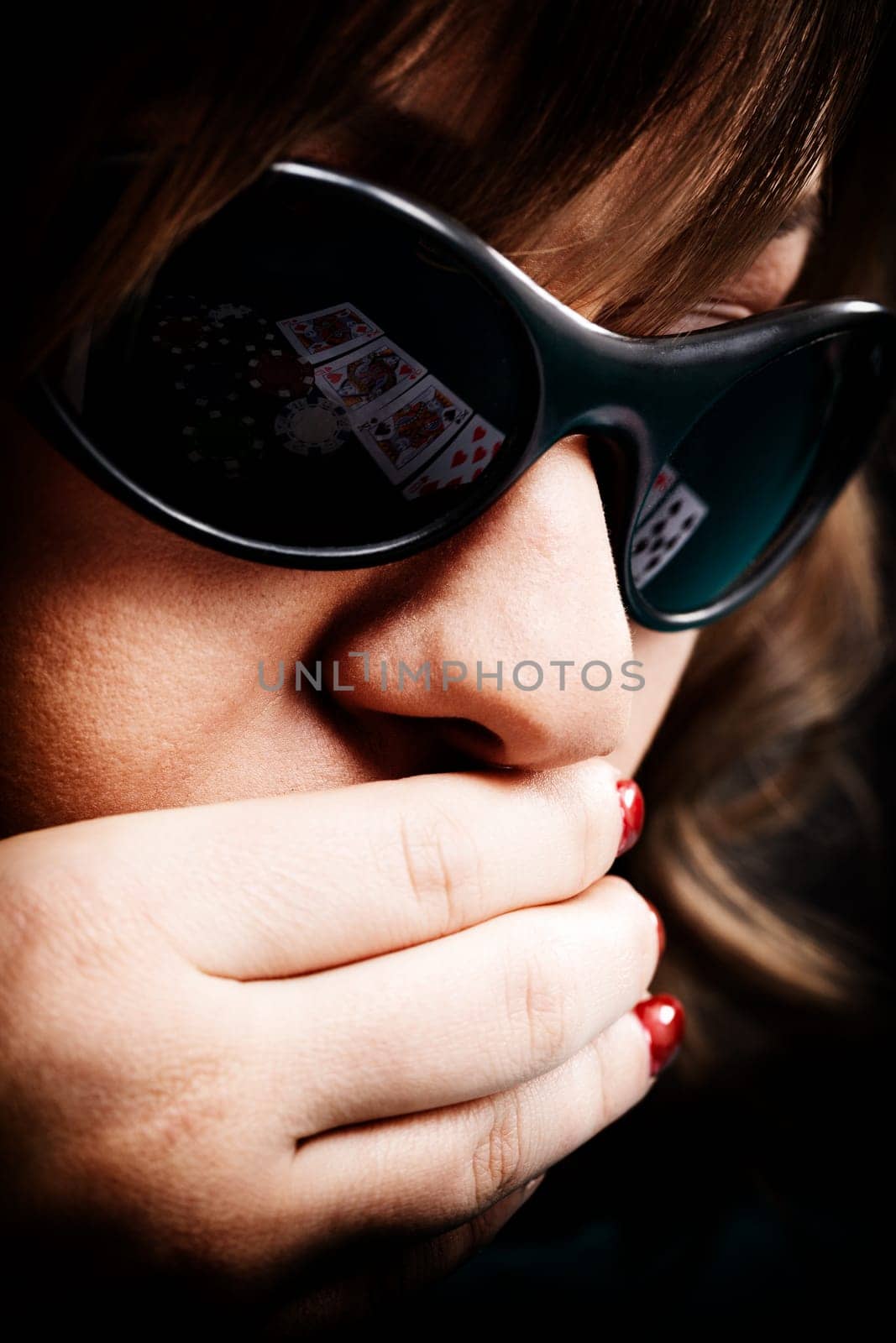 Young woman with black sunglasses reflecting cards