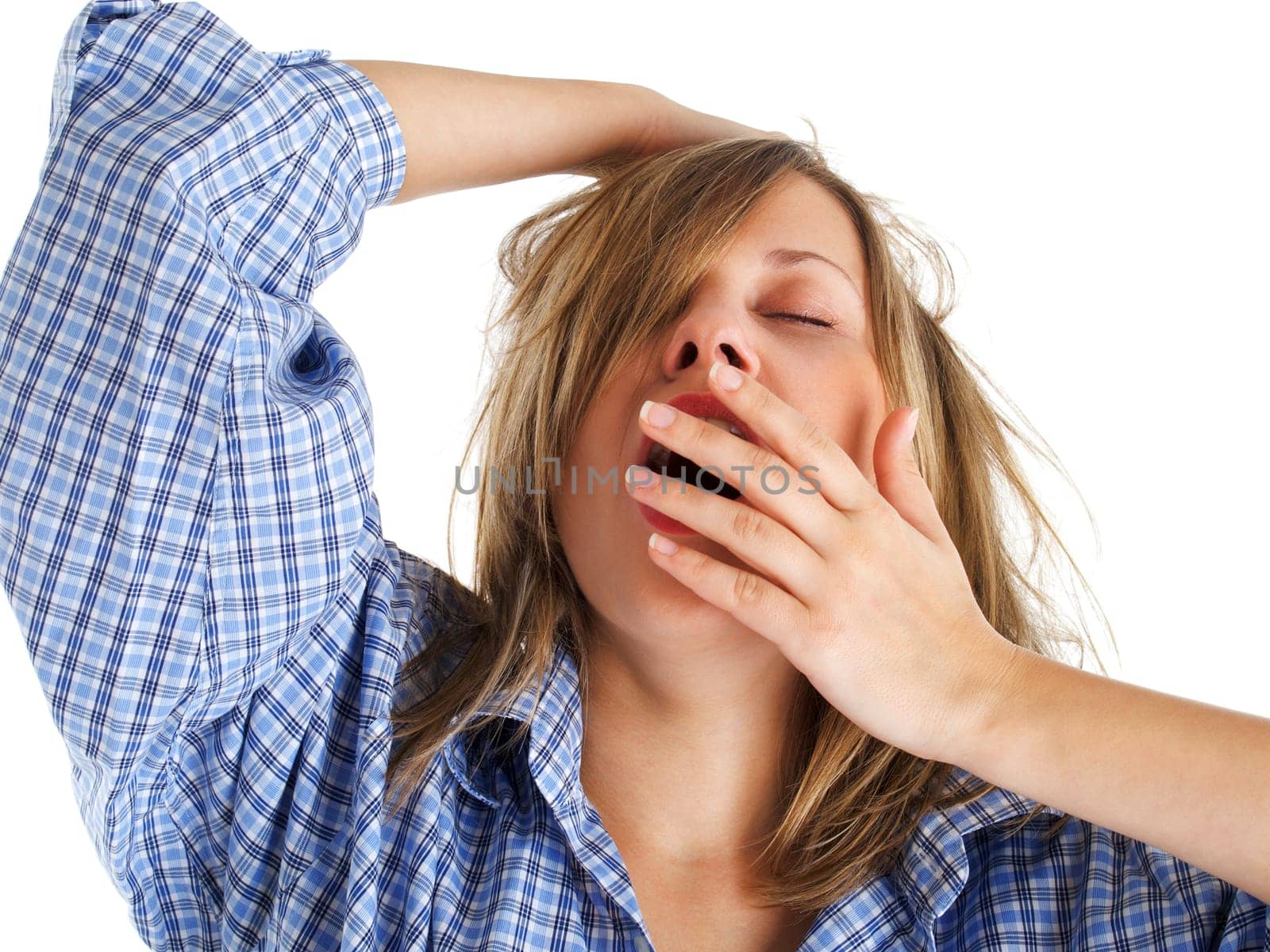Young woman yawning isolated on white