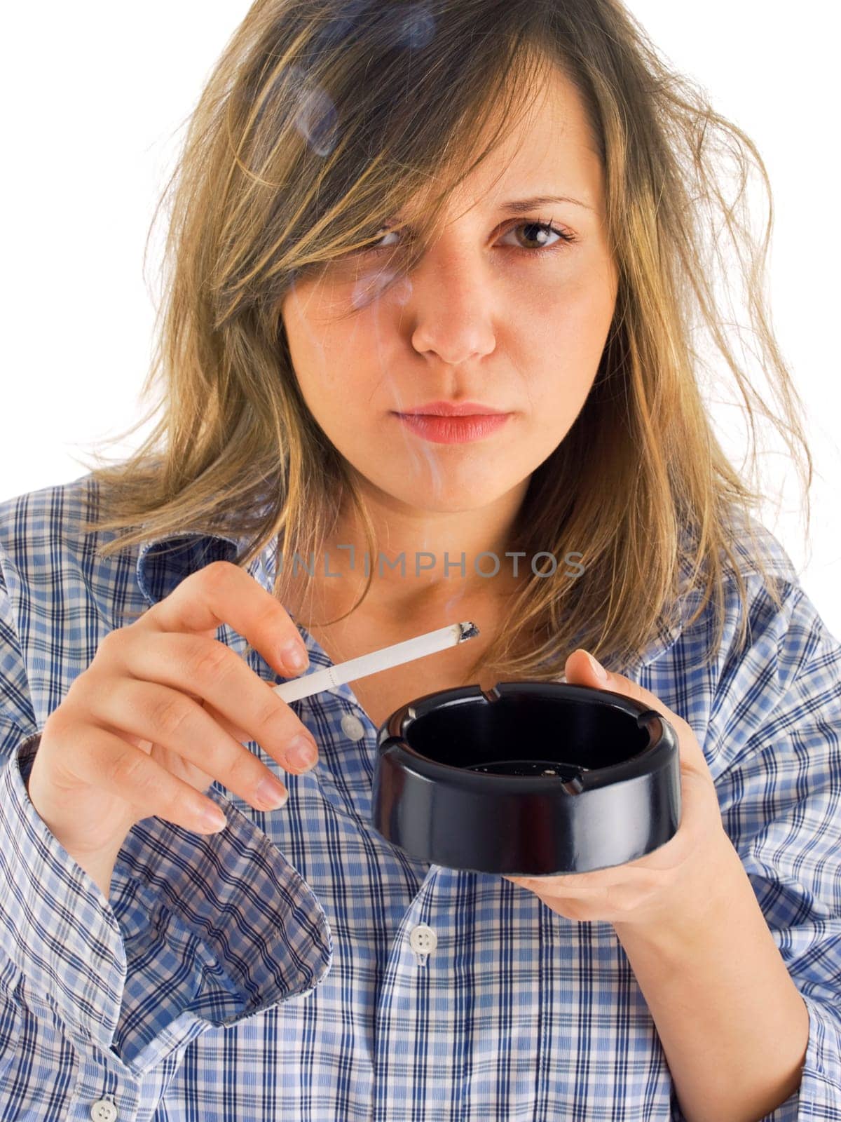 Young woman smoking isolated on white
