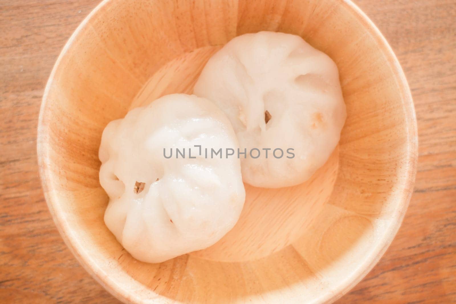 Steamed dumpling stuff on wooden bowl, stock photo
