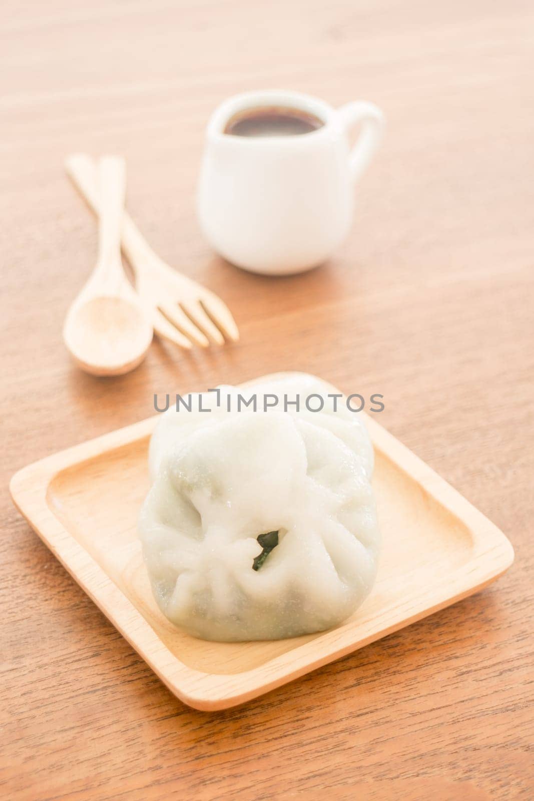 Steamed dumpling stuff serving on wooden plate, stock photo
