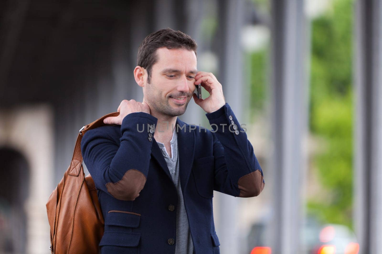 Young attractive man using smartphone in Paris, France