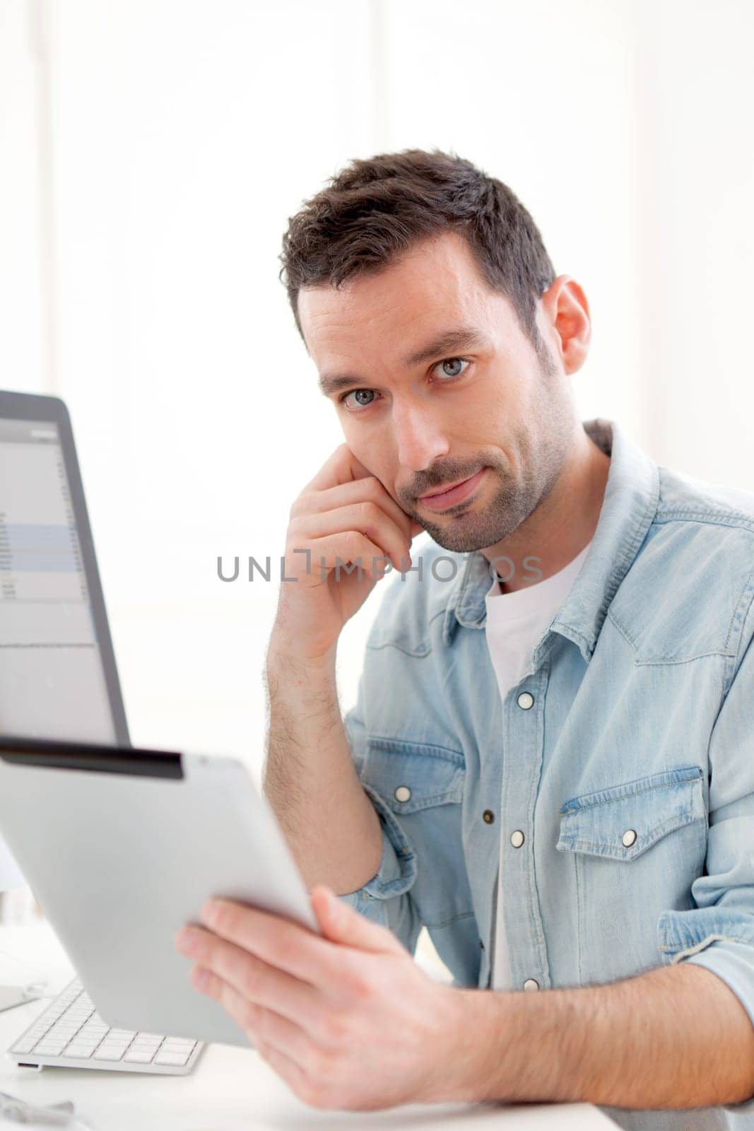 View of a Young relaxed man using tablet at home