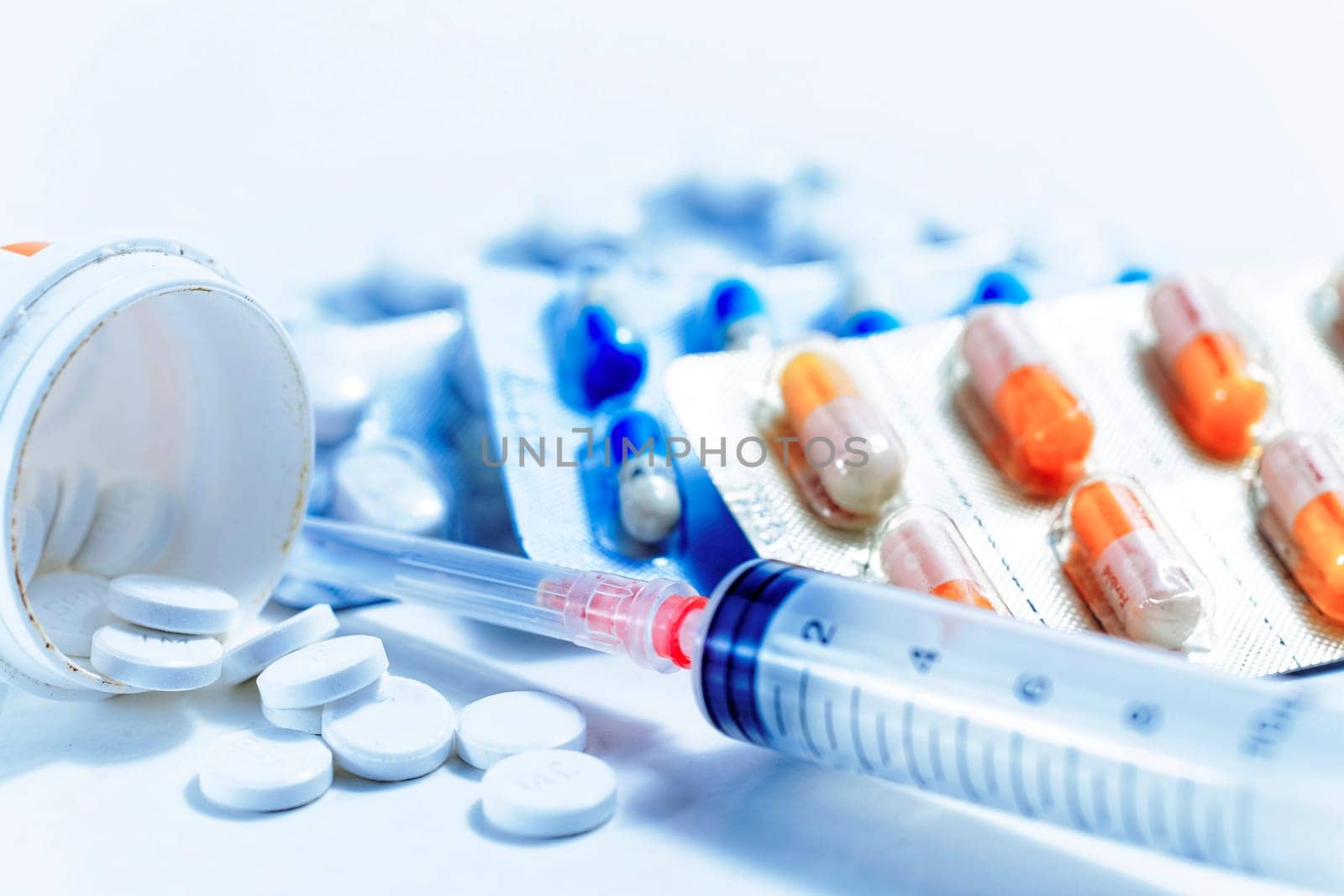 Syringe with glass vials and medications pills drug