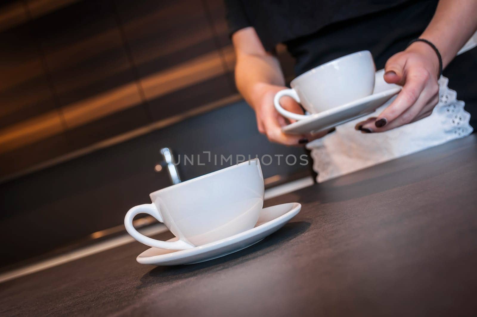 Waitress preparing coffee ready to serve at the counter of a cafe