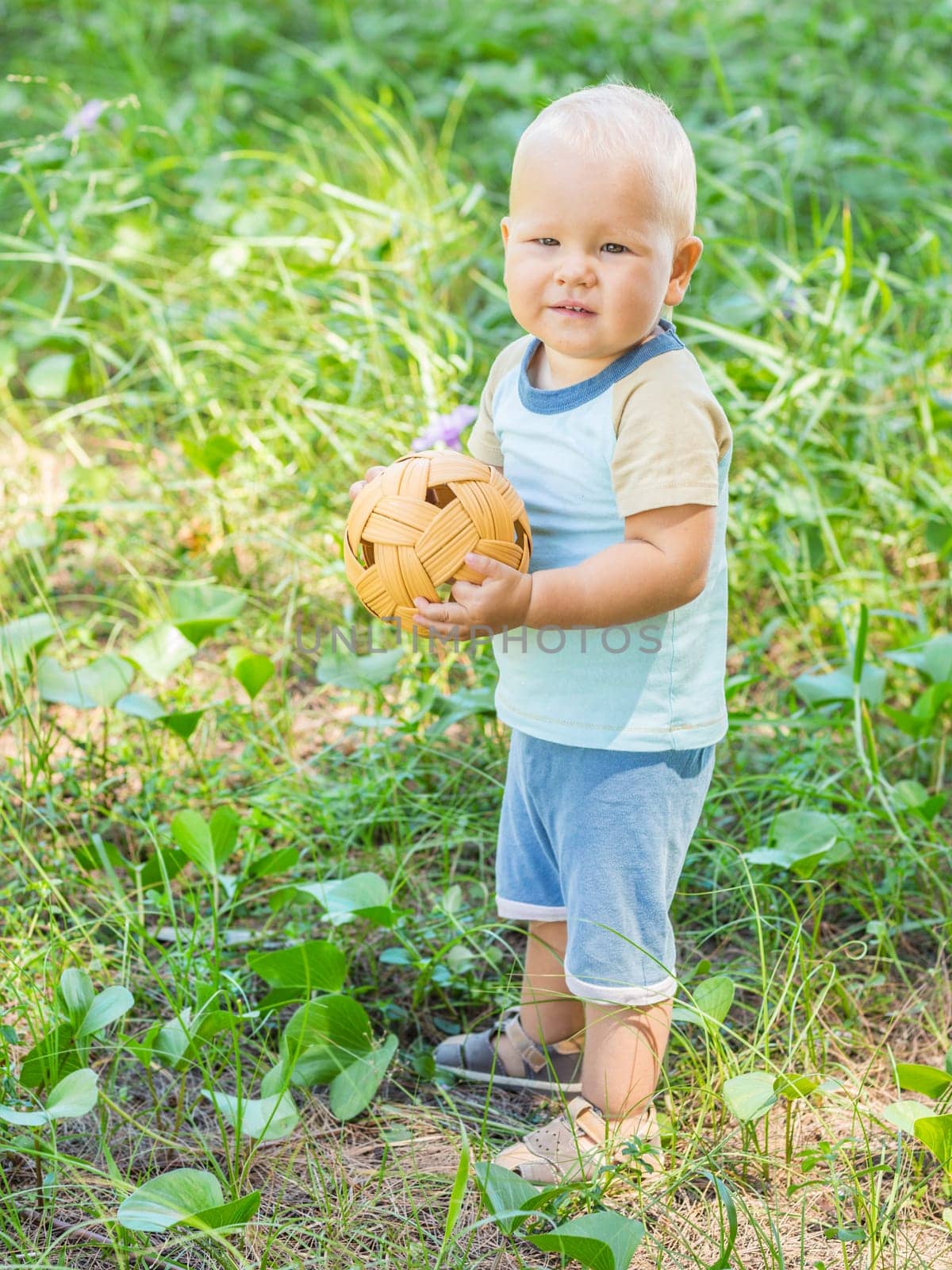 Baby playing with wicker ball