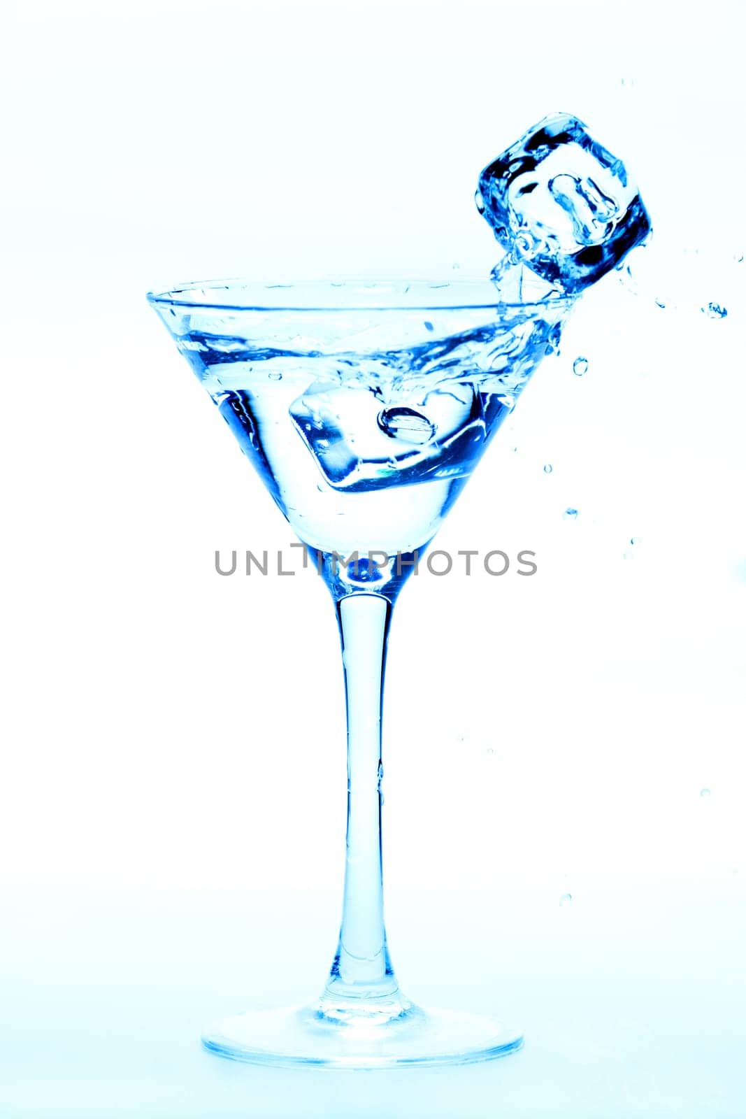 Martini splash with ice cubes