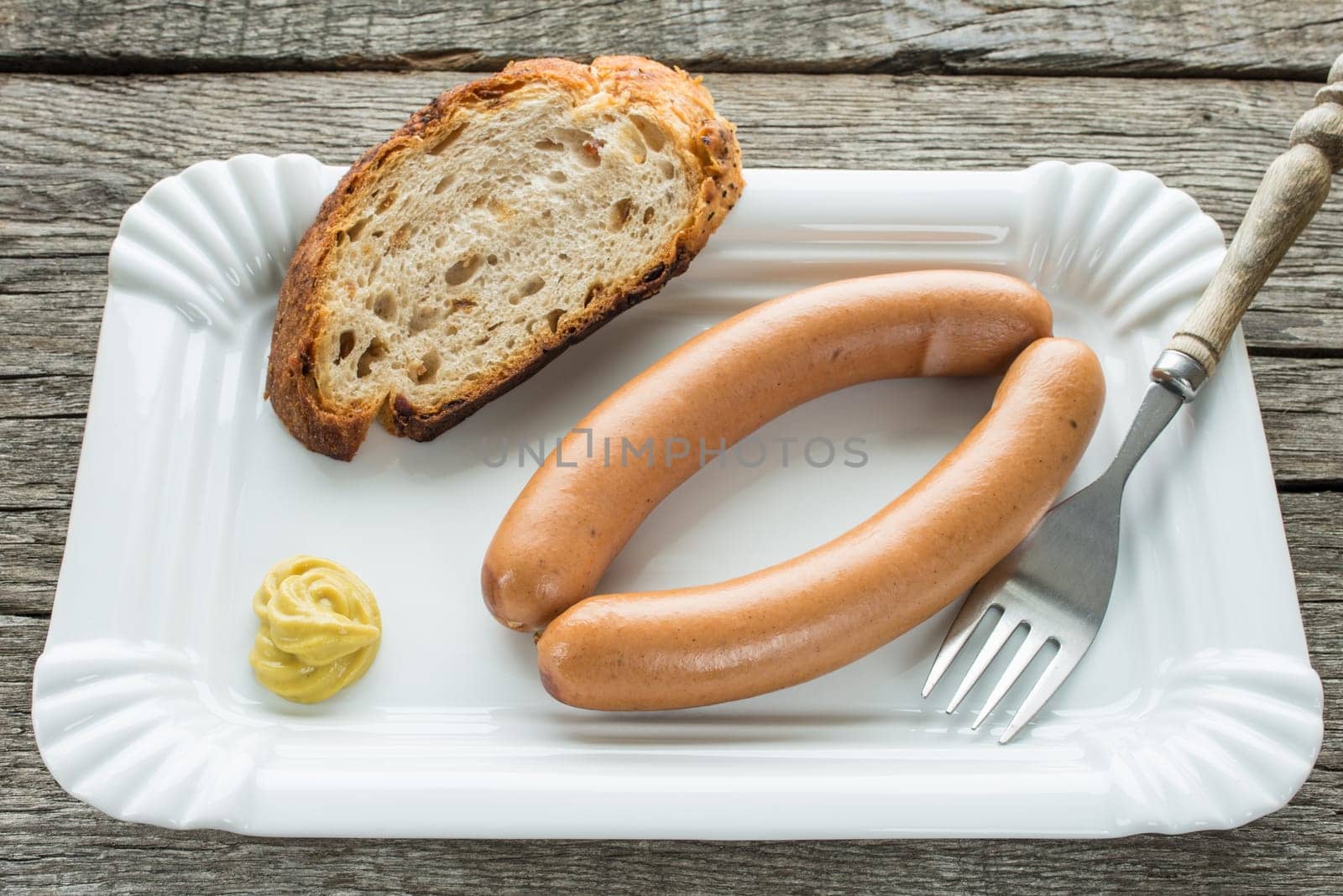 Viennese sausages with fork and mustard