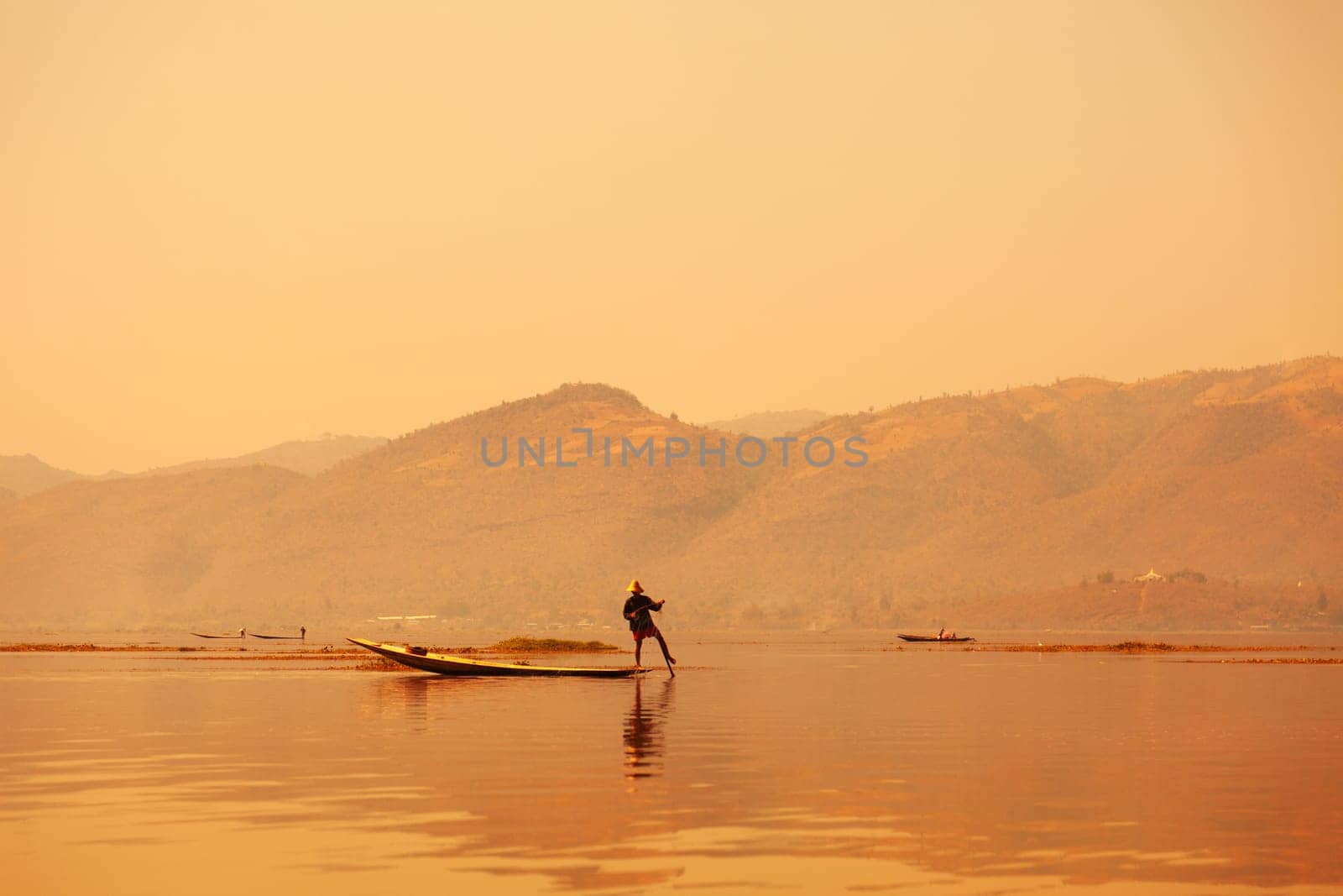 In Inle Lake it is typical to see intha fishermen who propel their crafts by leg rowing, a technique believed to date back to the 12th century. Standing up on one leg in the narrow stern of the boat, a fisherman wraps his other leg around an oar and, with a circular movement, propels his boat forward.