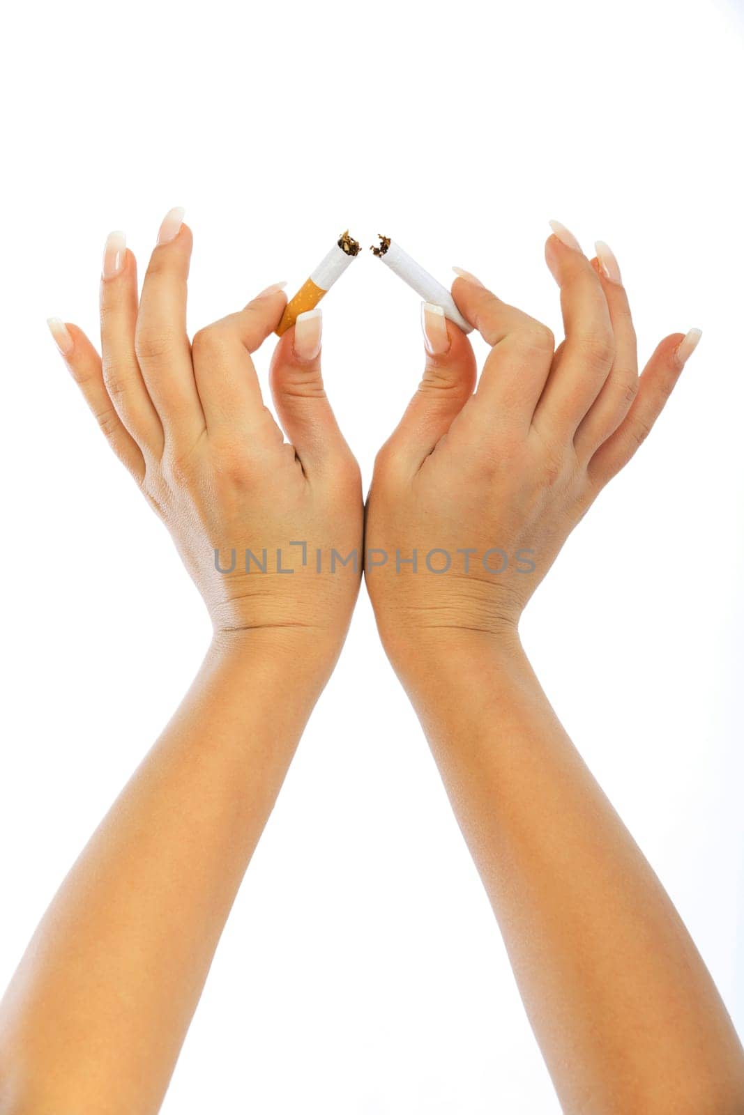 Young woman breaking a cigarette - close up of her hands