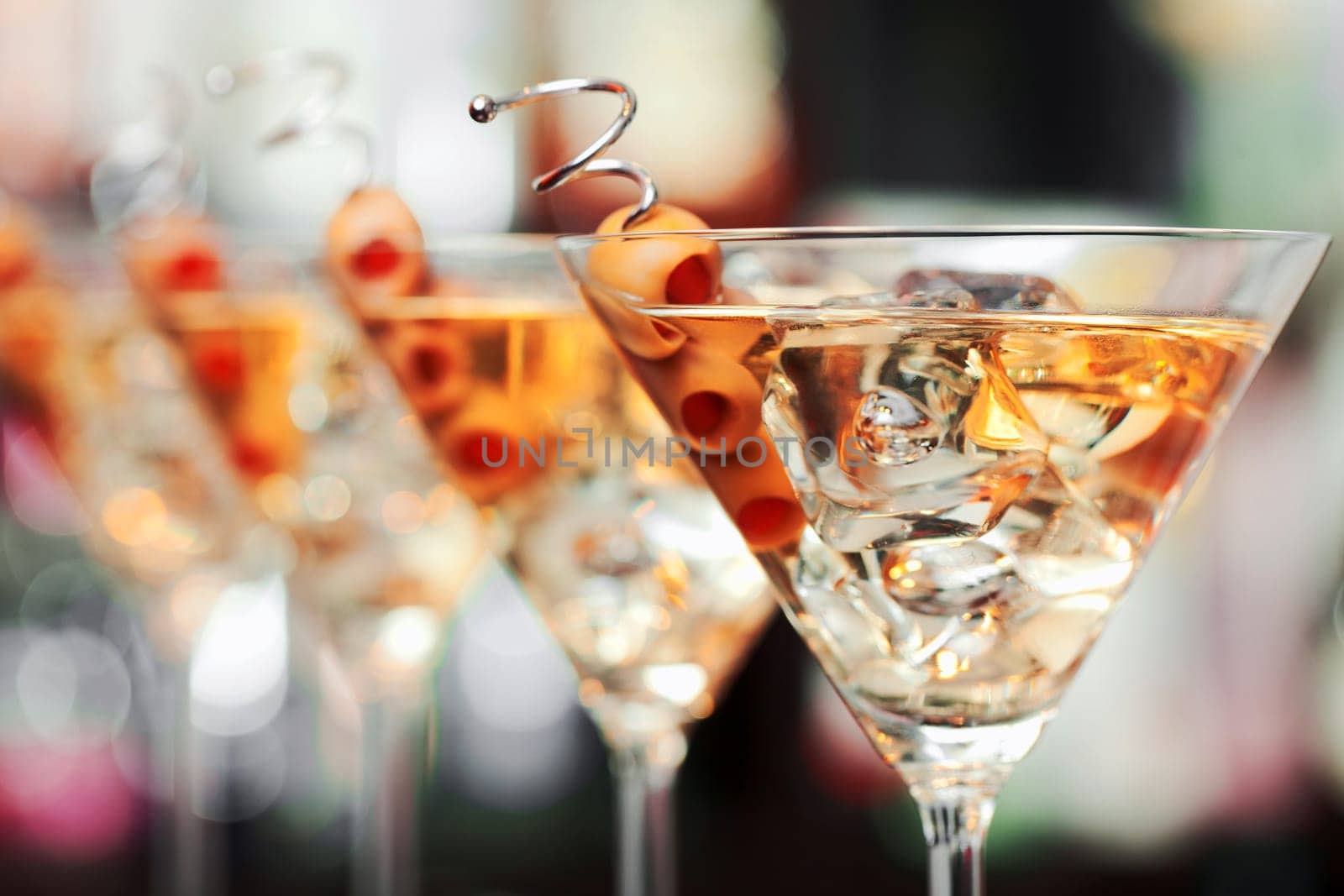 Several glasses of famous cocktail Martini, shot at a bar with shallow depth of field..Ingredients