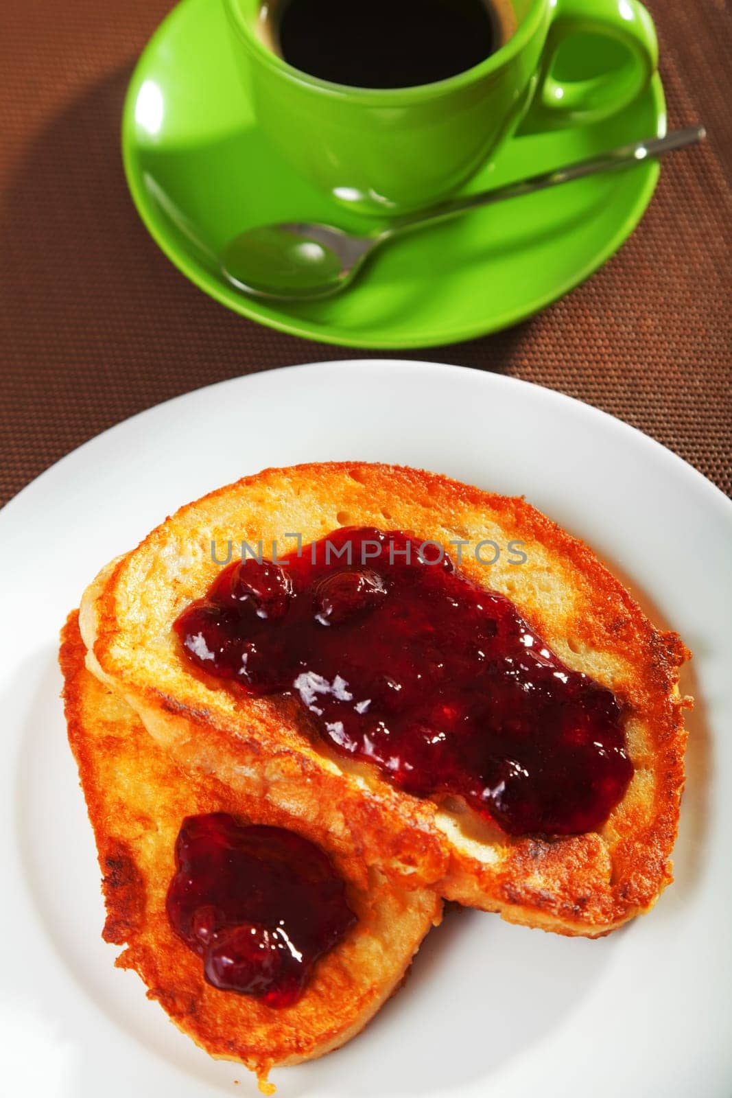 Breakfast with french toast with jam and cup of coffee