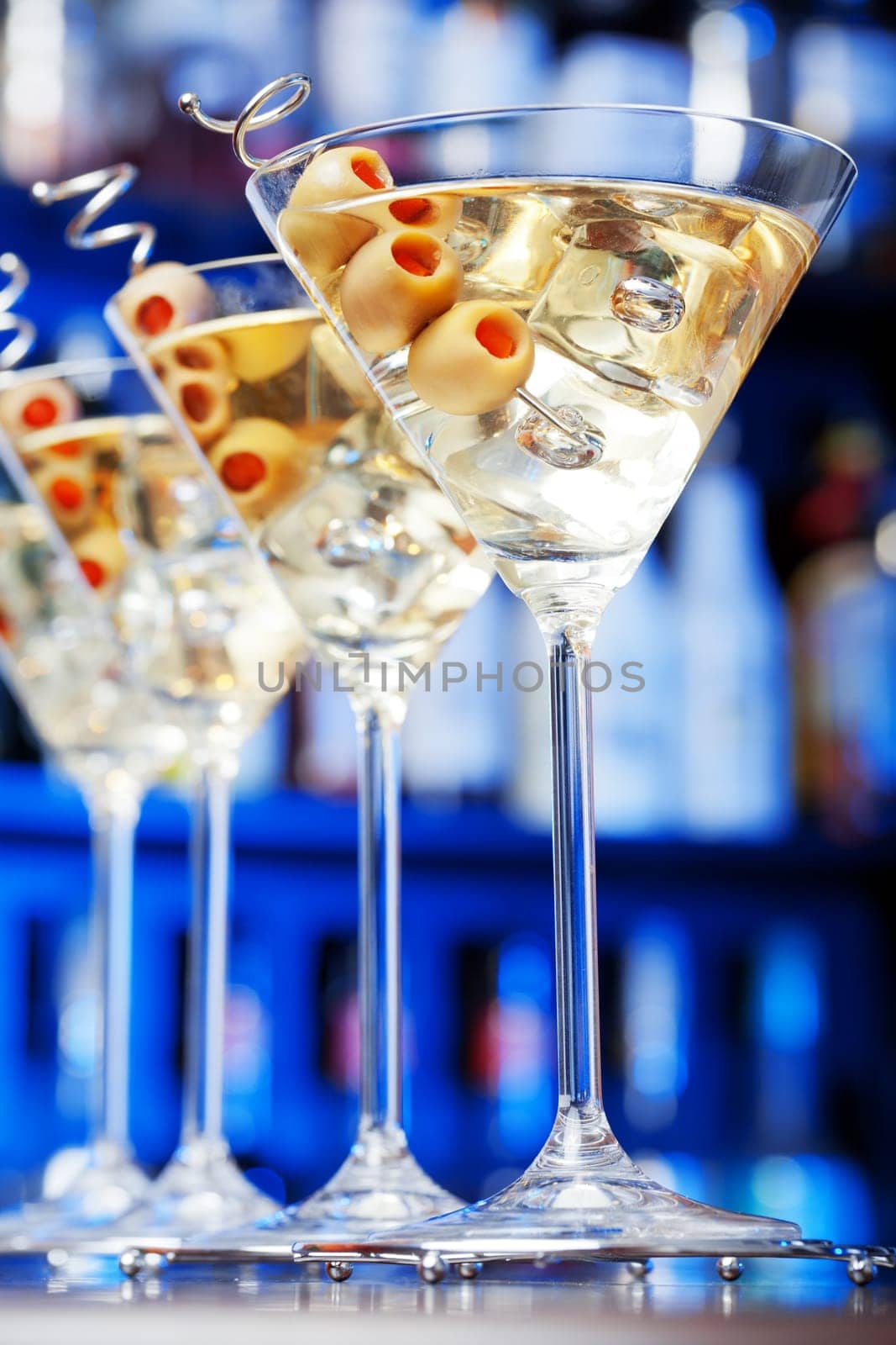 Several glasses of famous cocktail Martini, shot at a bar with shallow depth of field..Ingredients
