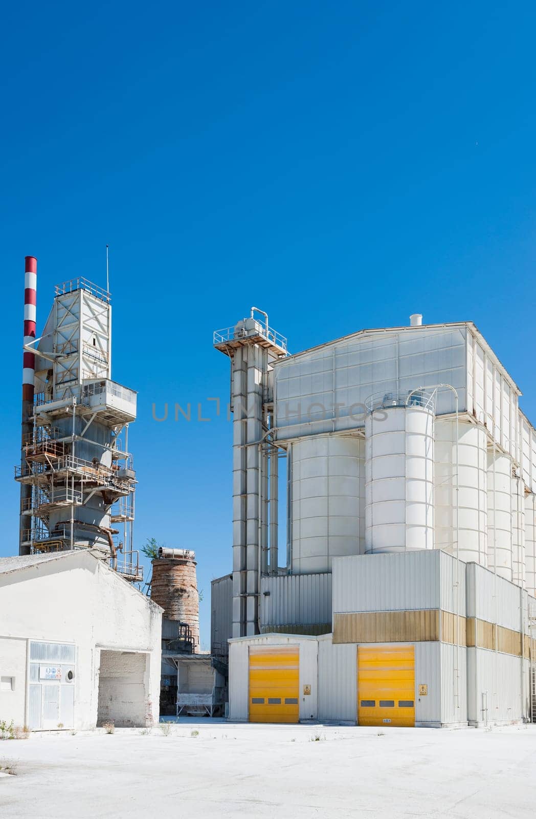 Old cement plant. Preheating tower and storage silos