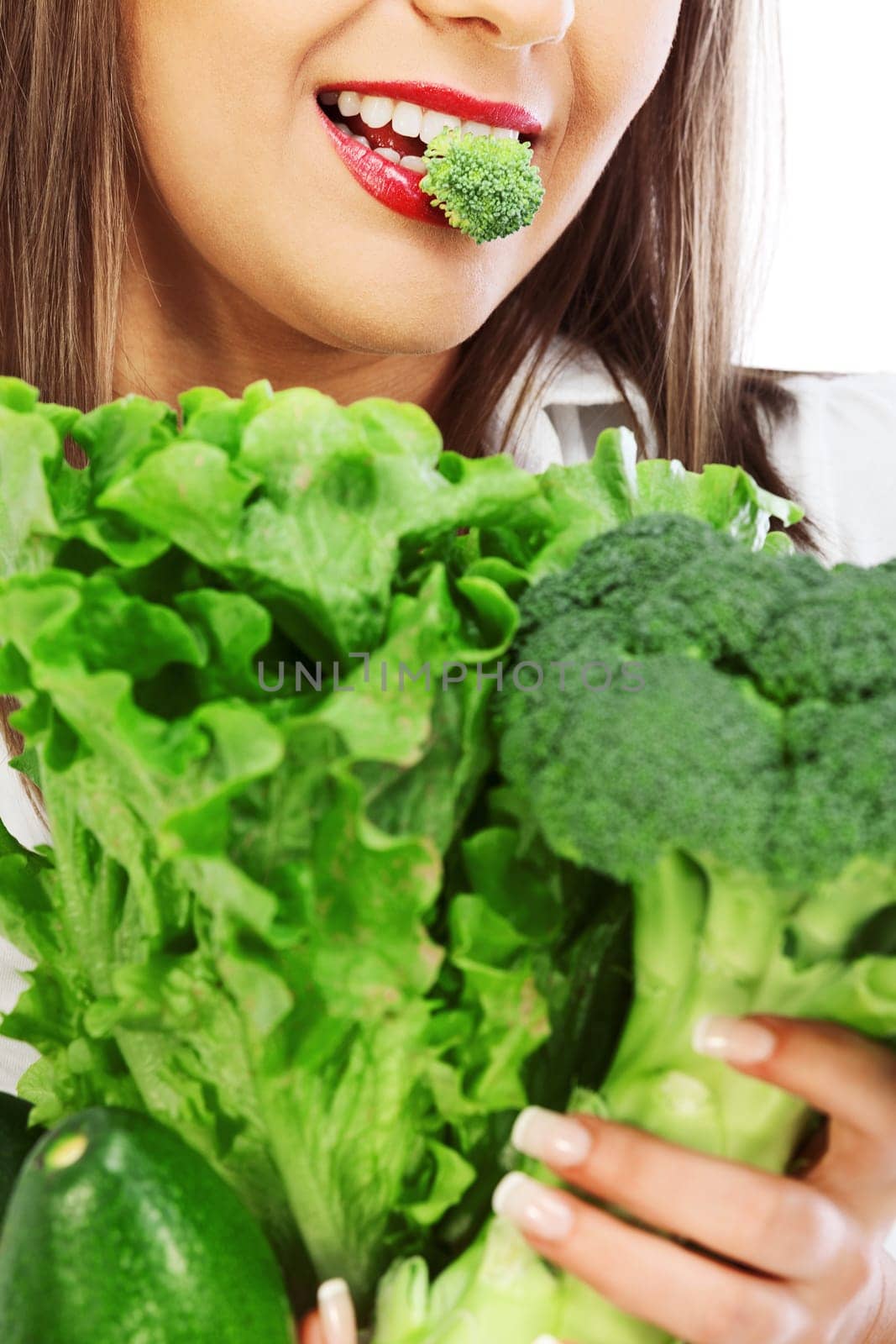 Young woman eating fresh salad isolated on white