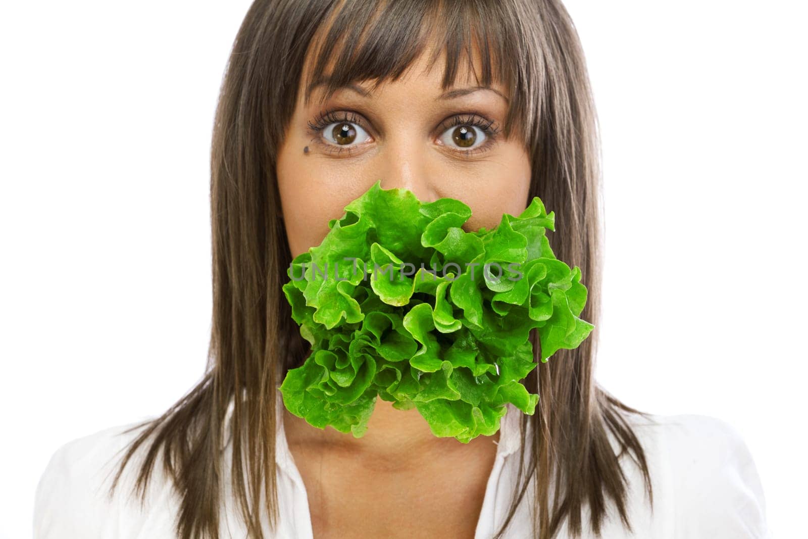 Young woman eating fresh salad isolated on white