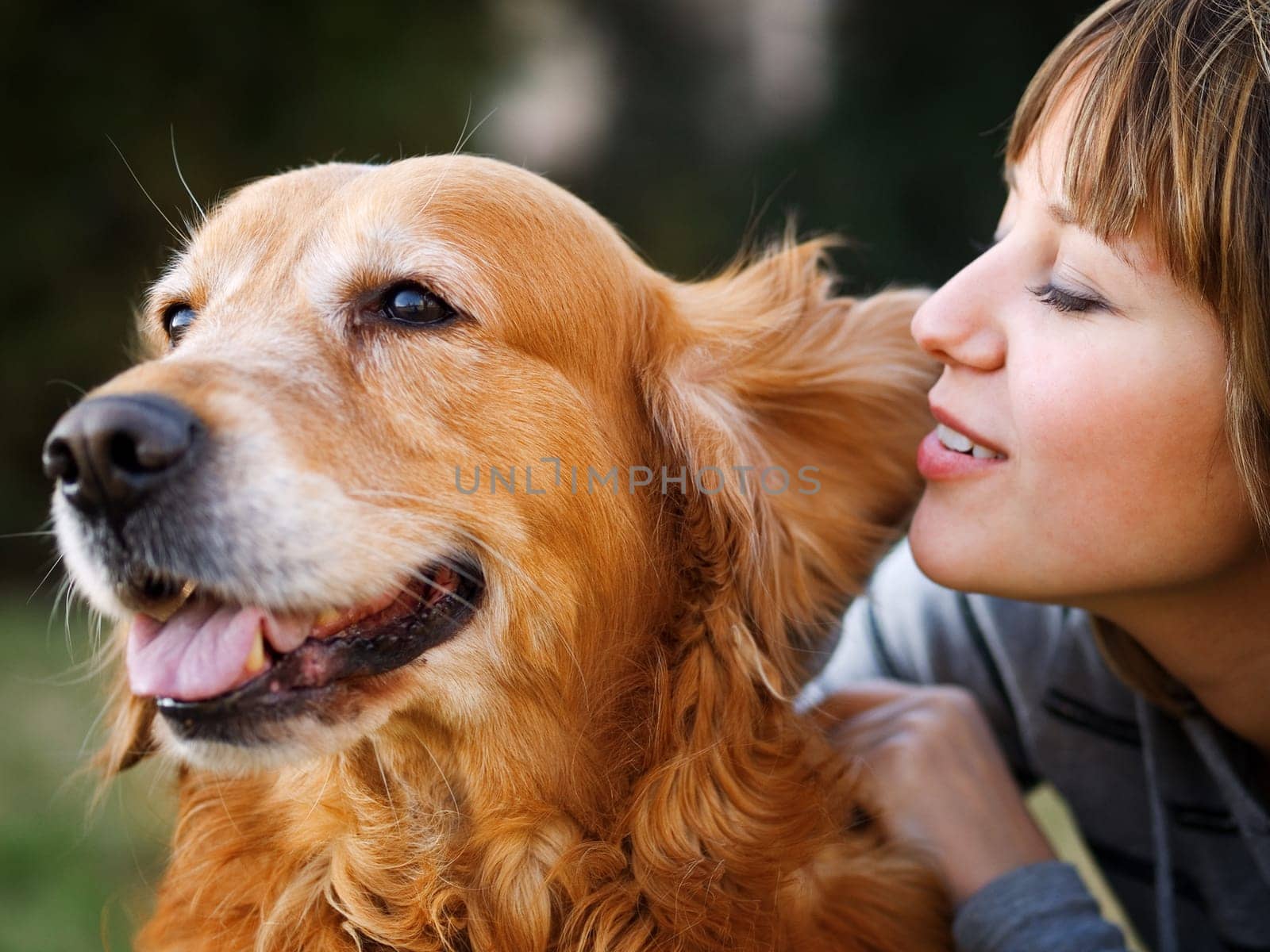 Girl whispering in her dog's ear