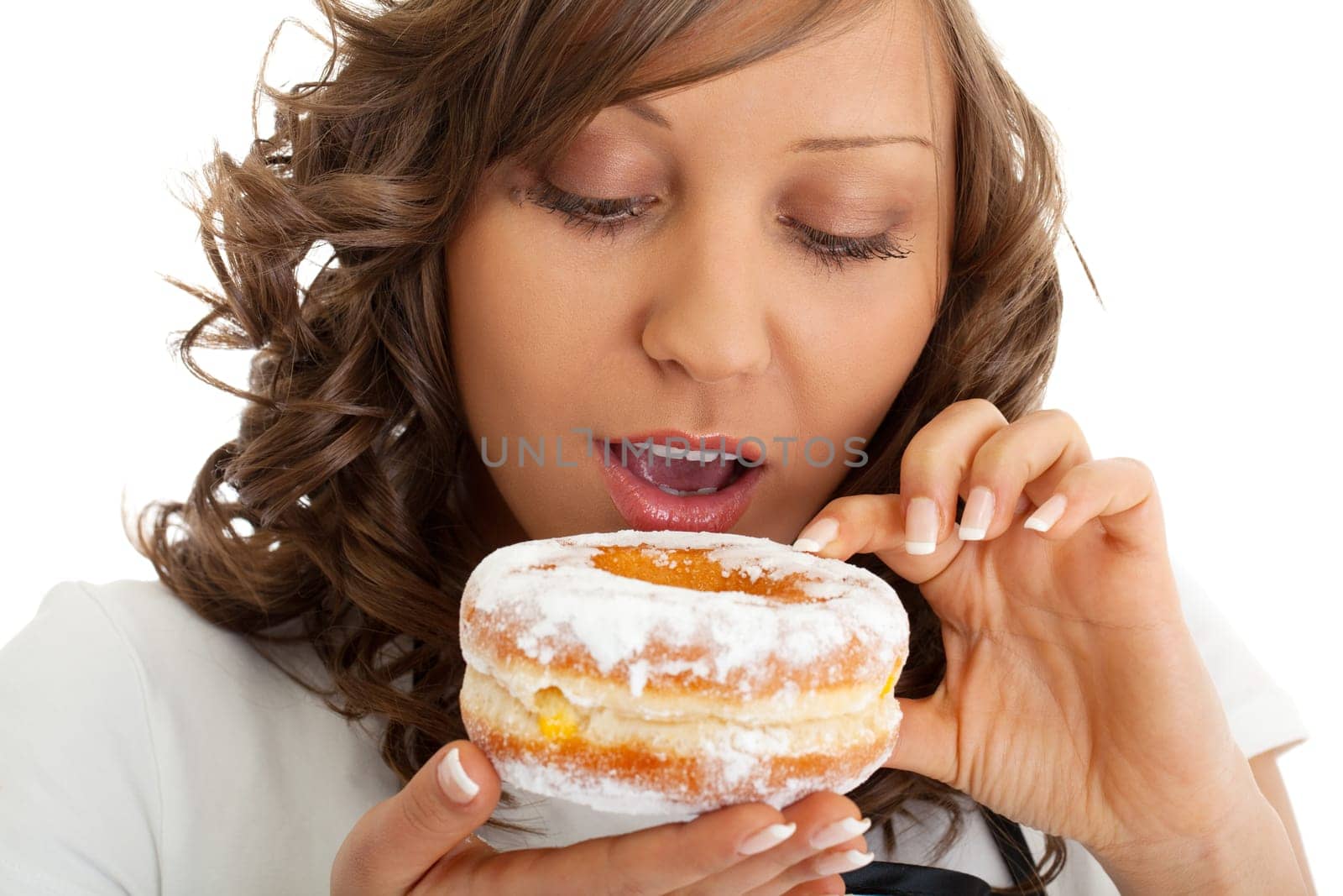 Young woman as chef eating donut, close up