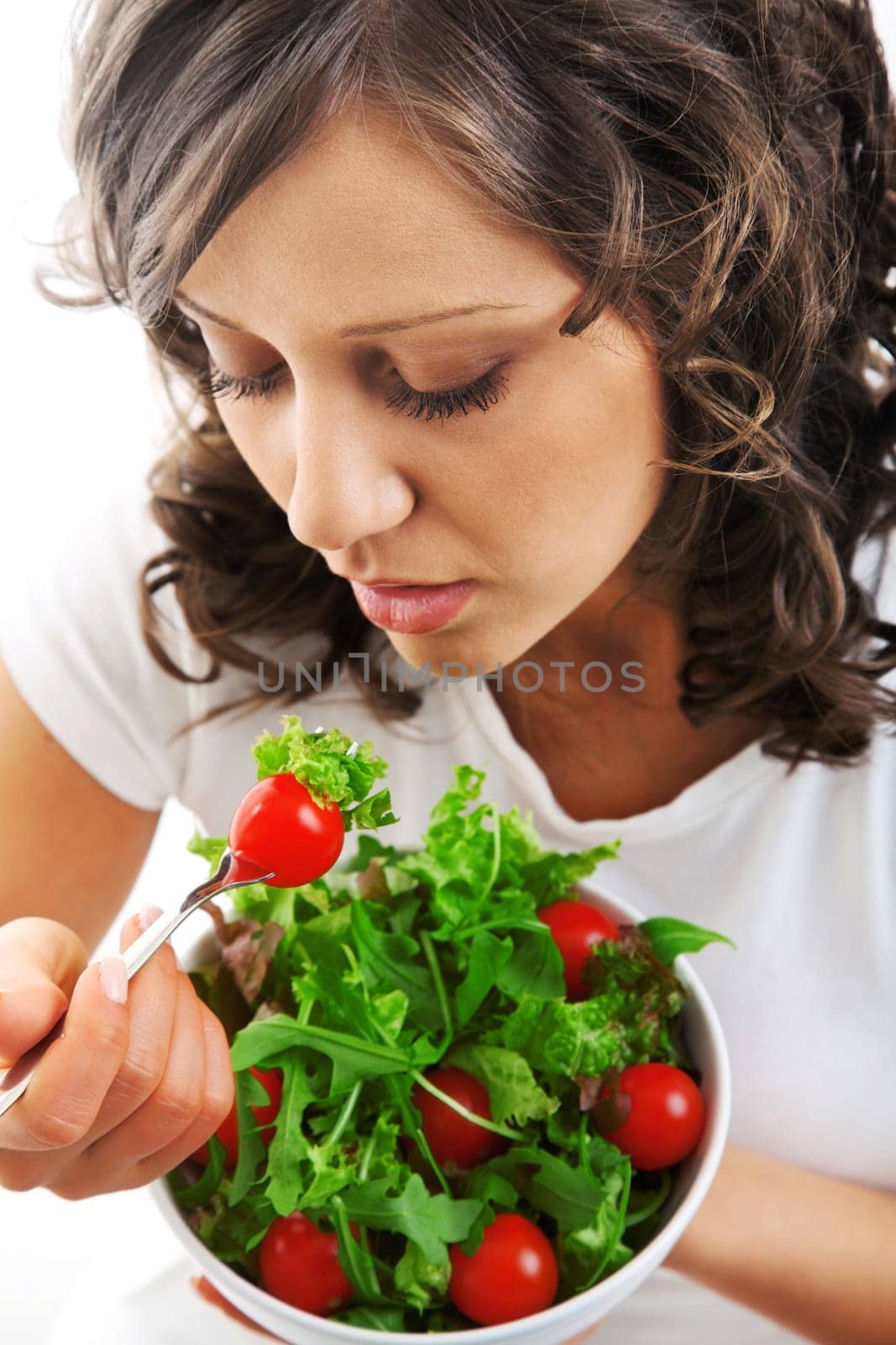 Youg woman eating healthy salad isolated on white background