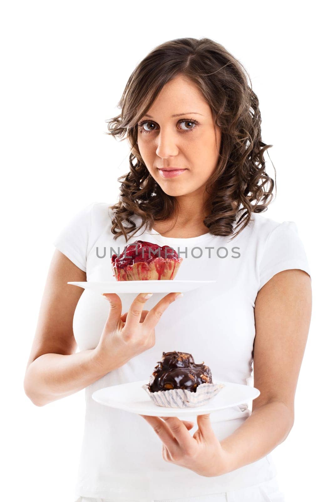 Young woman with two cakes - one with fruits and the other with chocolate