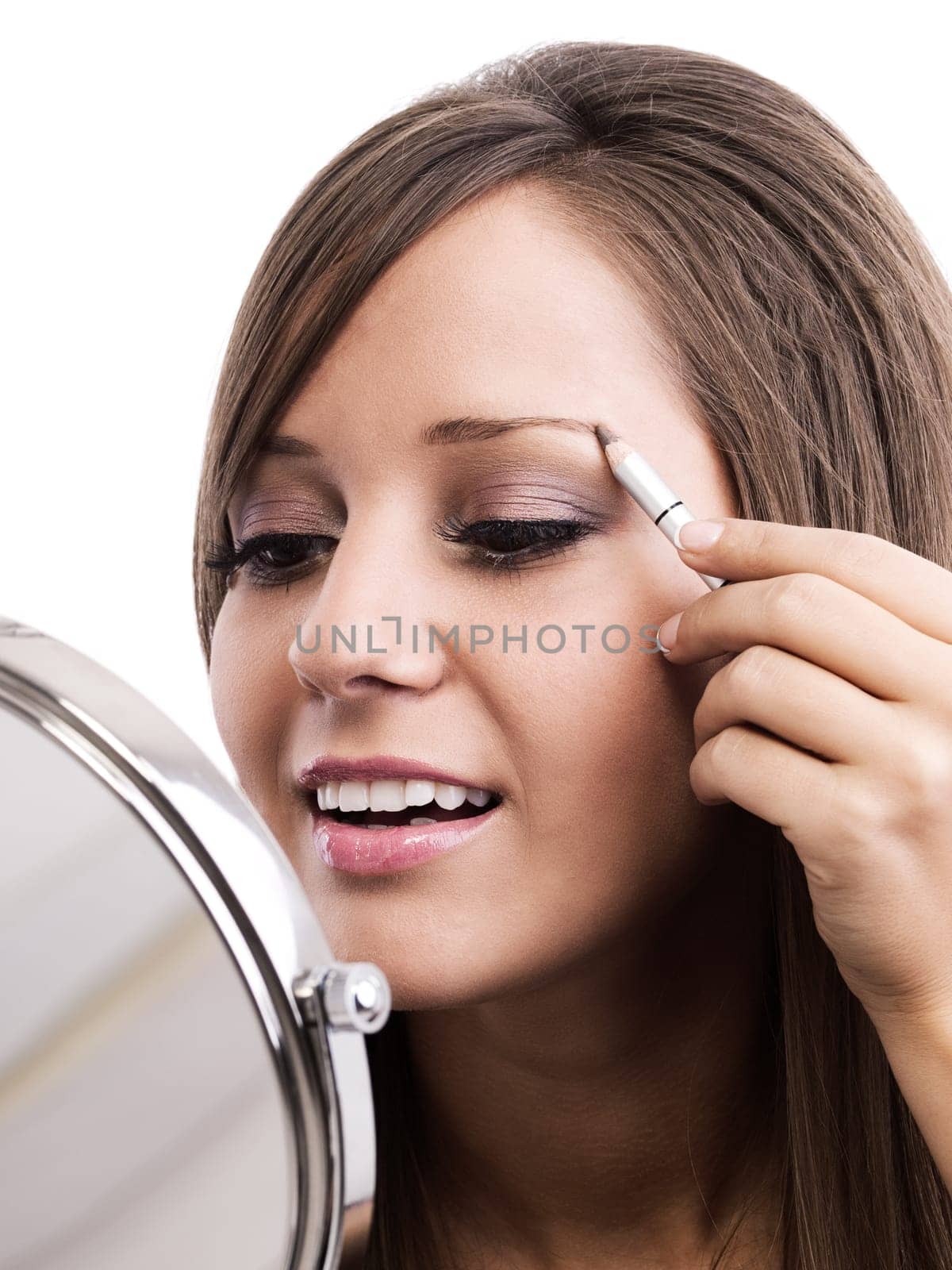 Applying make-up on young woman face, reflection in the mirror