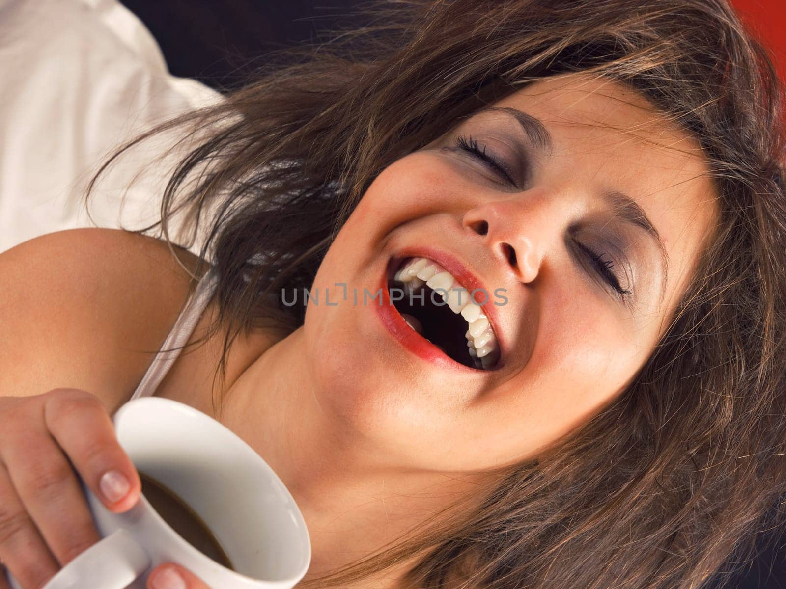 Woman in bed with coffee