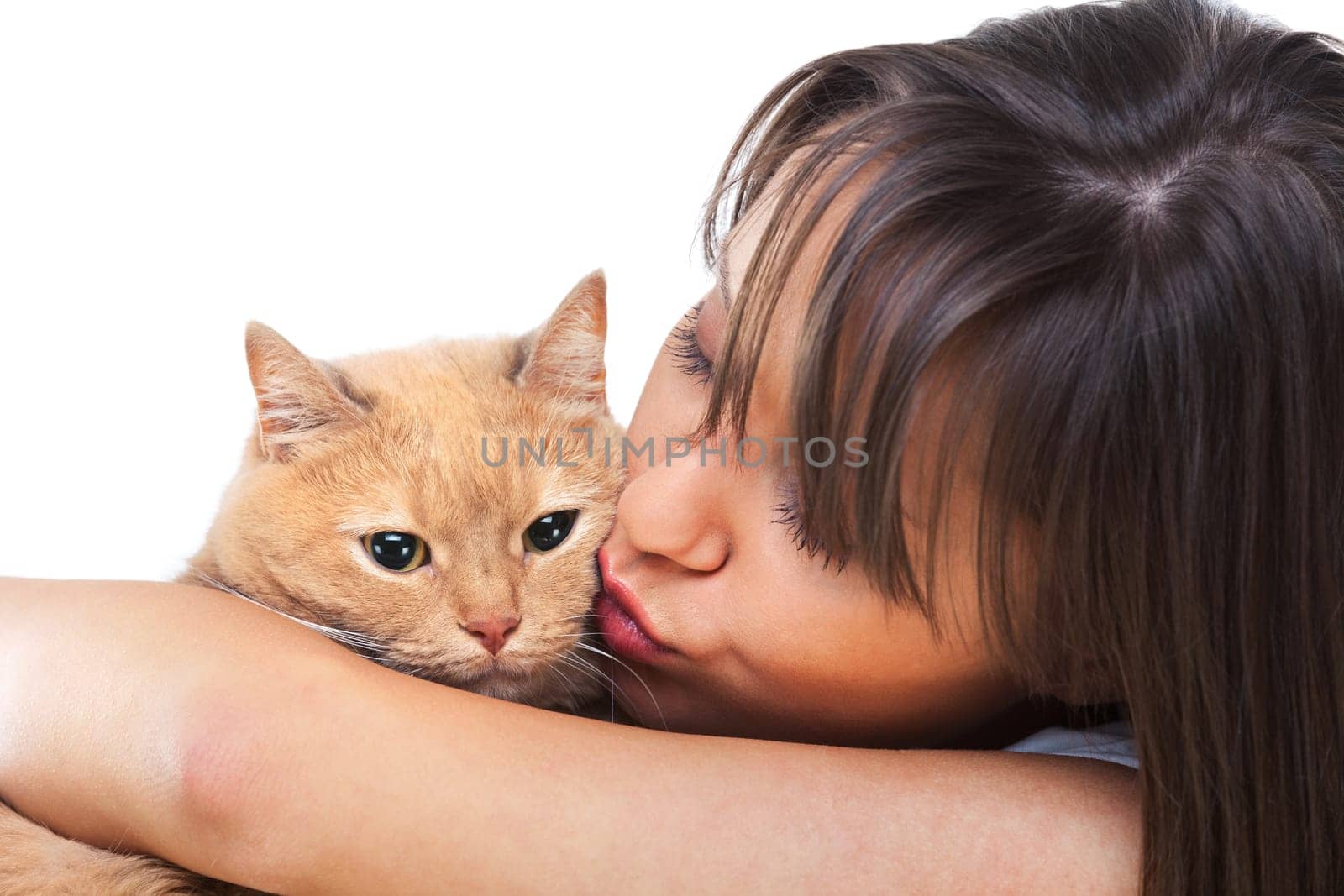 Young woman posing at camera with redhaired domestic cat
