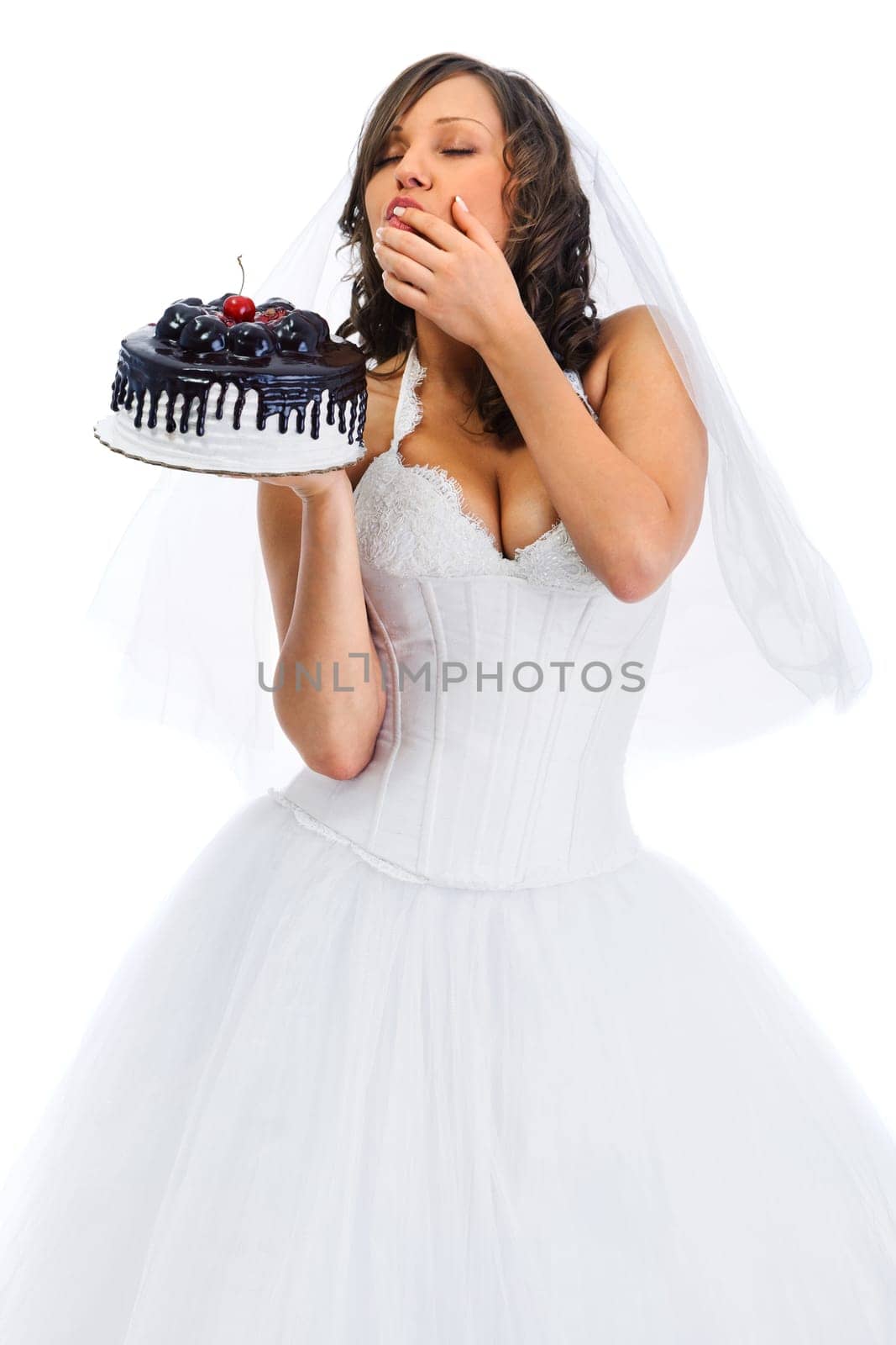 Young bride eating cake isolated on white background