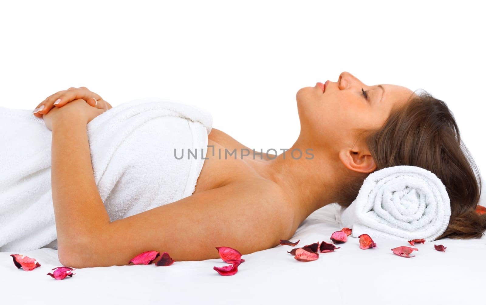 Young woman having a classical massage lying on white bed