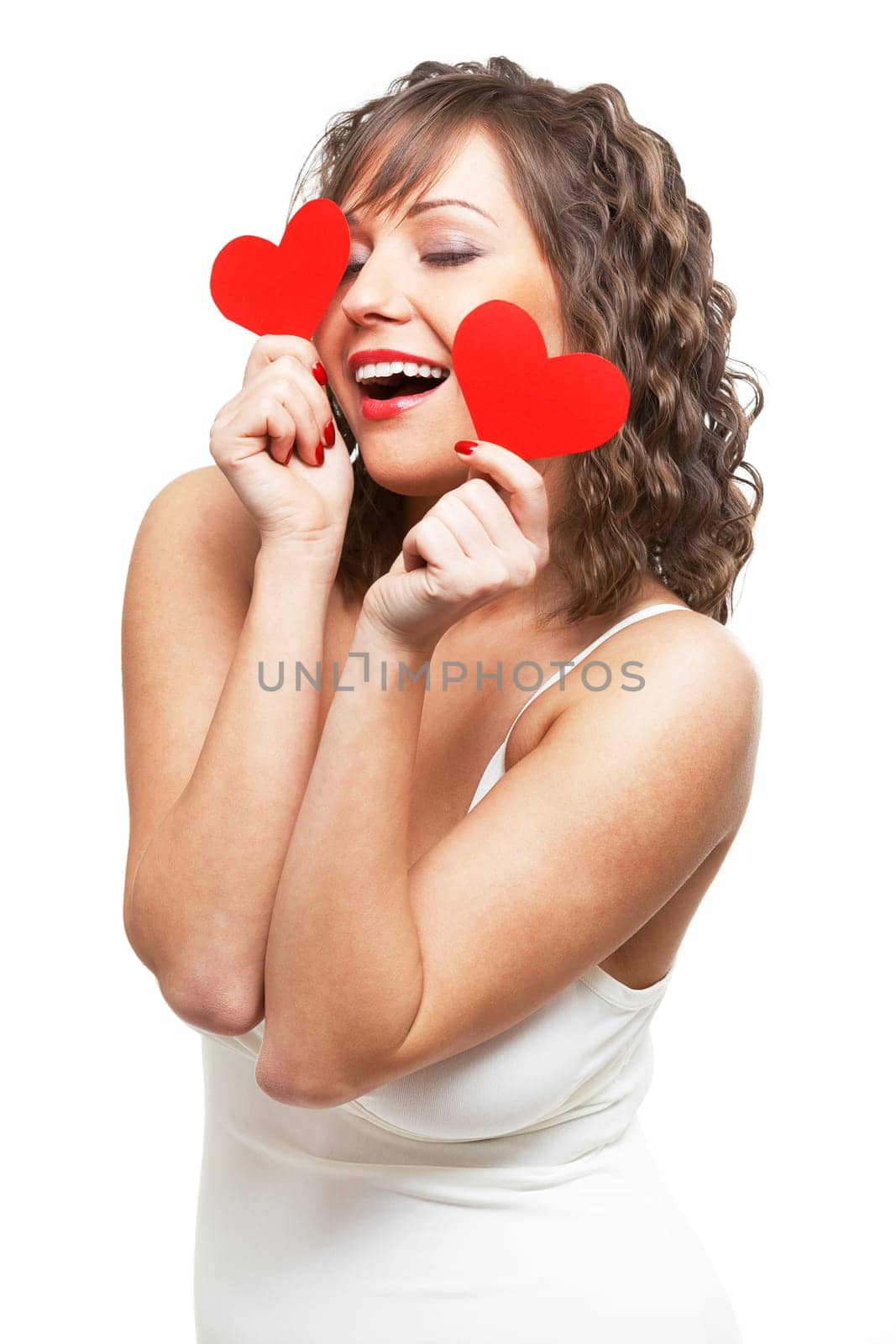Young attractive woman holding red paper heart like a valentine card and hiding her face