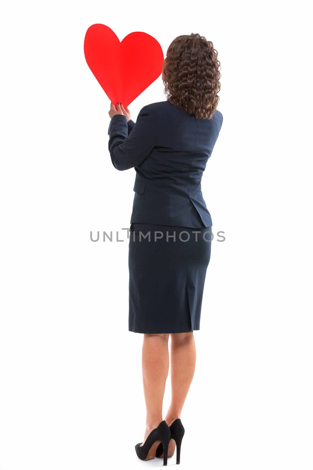 Businesswoman holding red paper heart like a valentine card