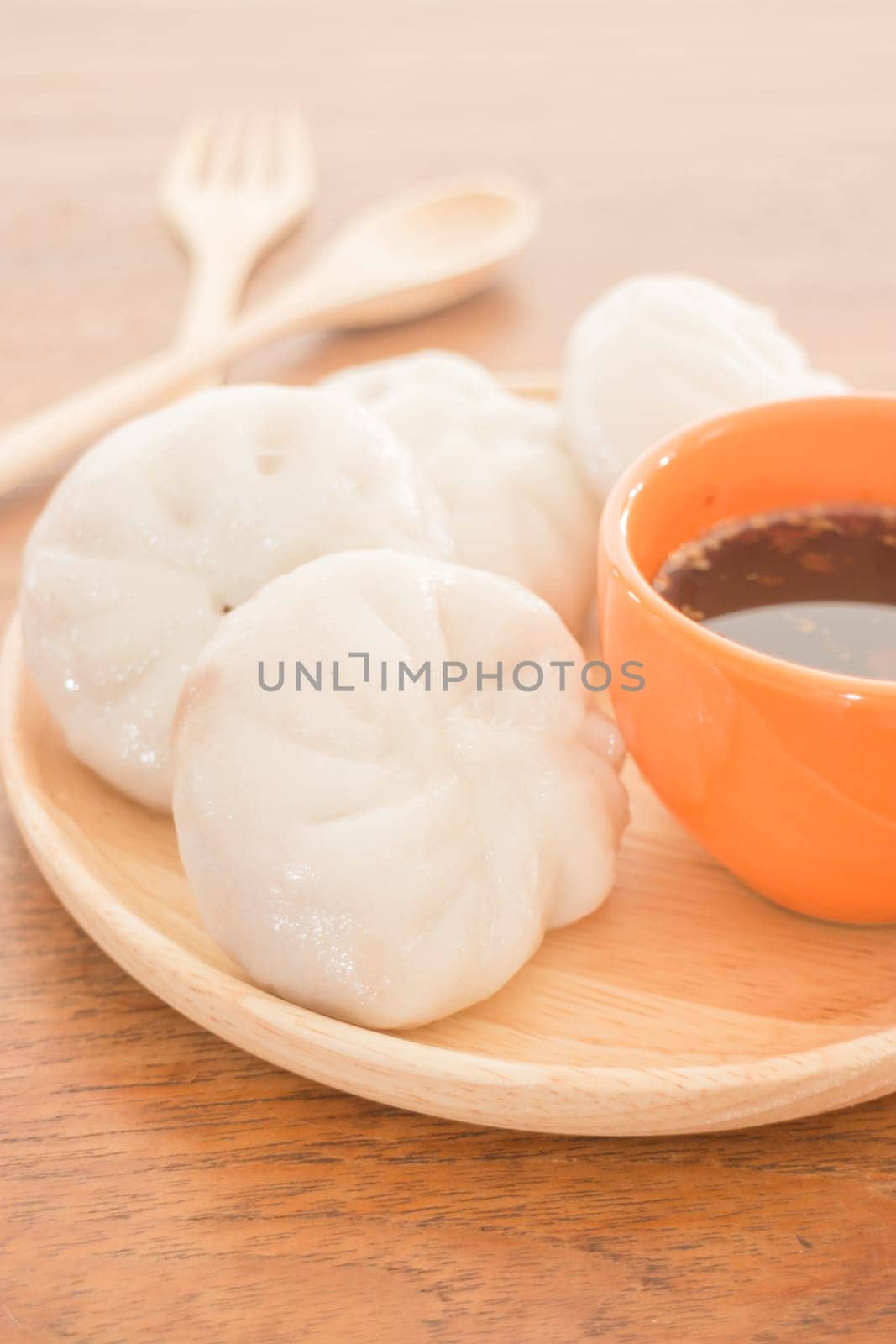 Steamed dumpling stuff on wooden plate, photo