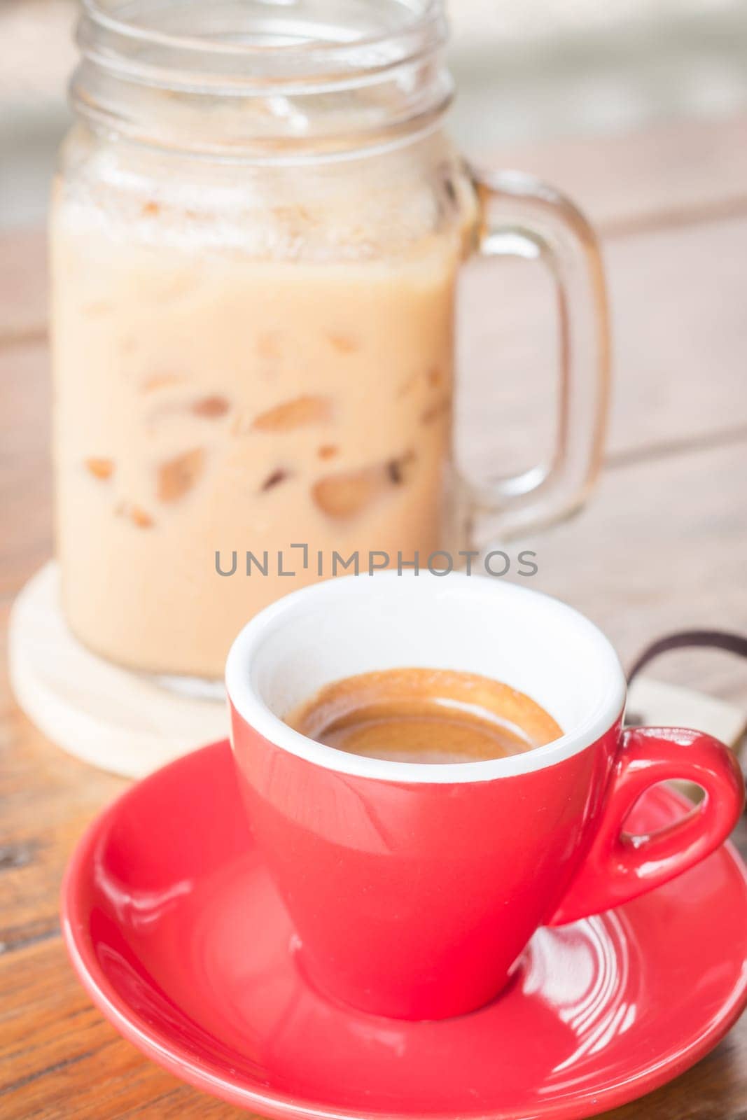 Hot and cold coffee on wooden table, stock photo