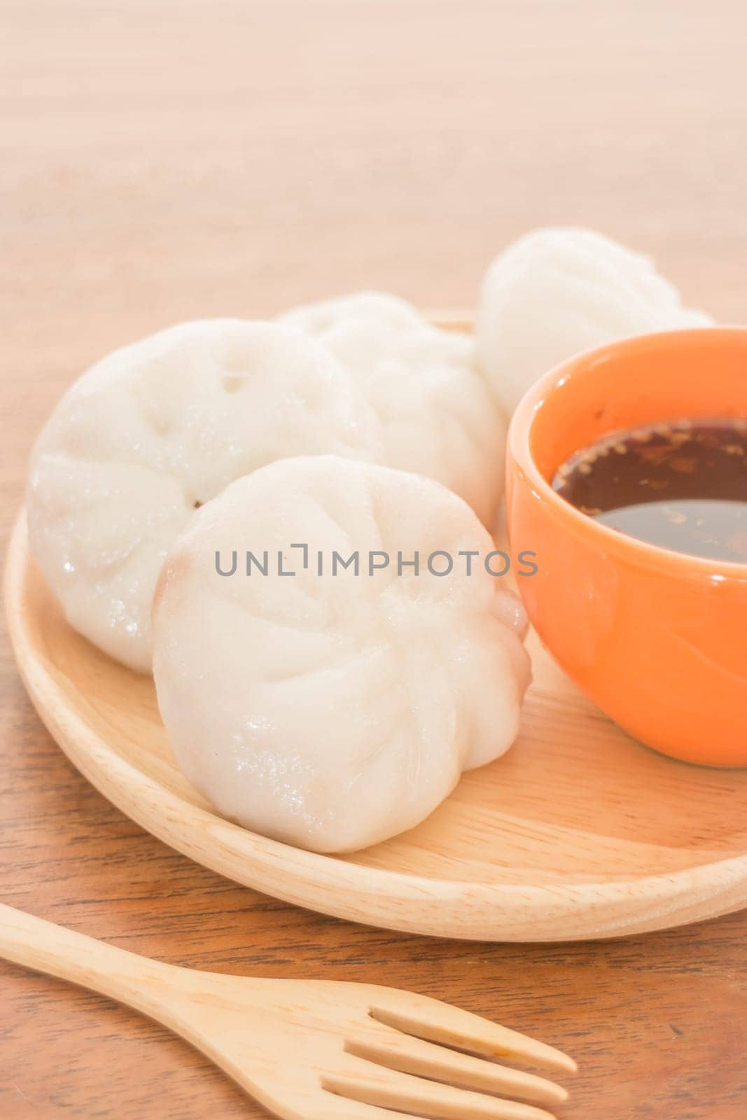 Steamed dumpling stuff on wooden plate, photo