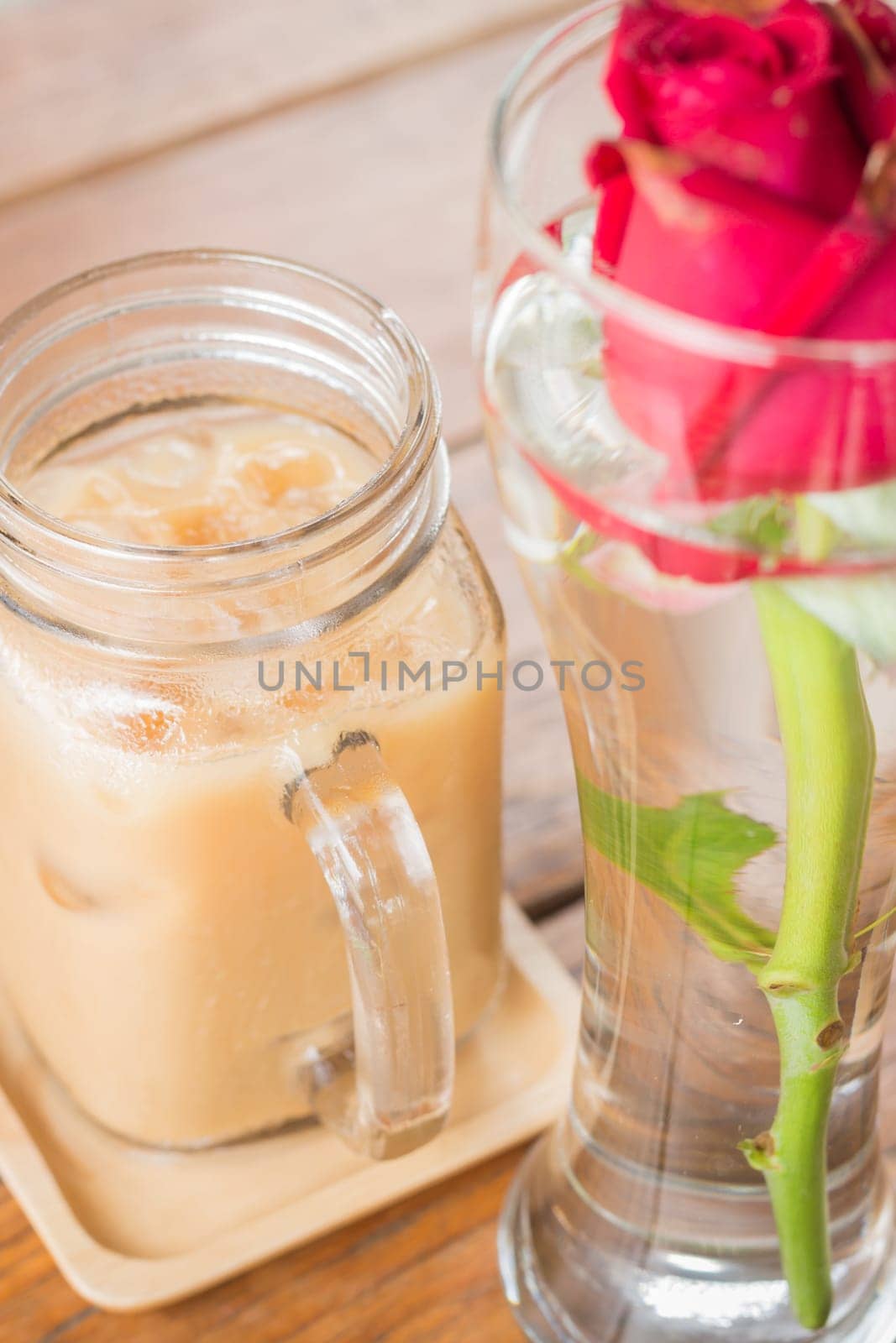 Iced milk coffee serving on wooden table, stock photo
