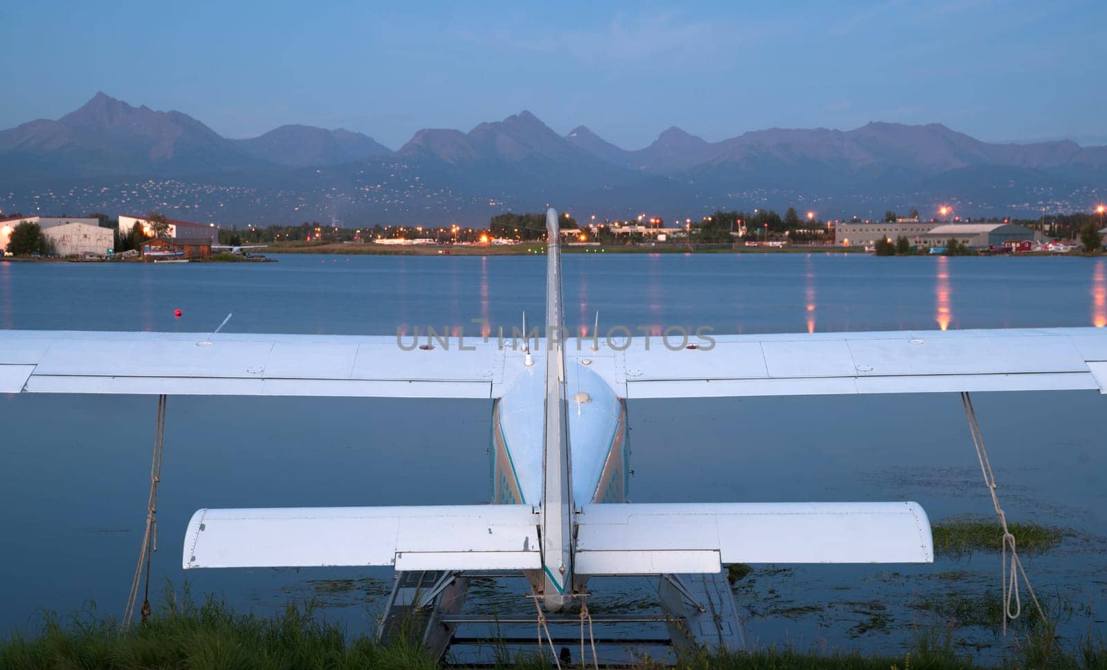 A plane sits waiting for the next chance to be of service as darkness falls on Anchorage