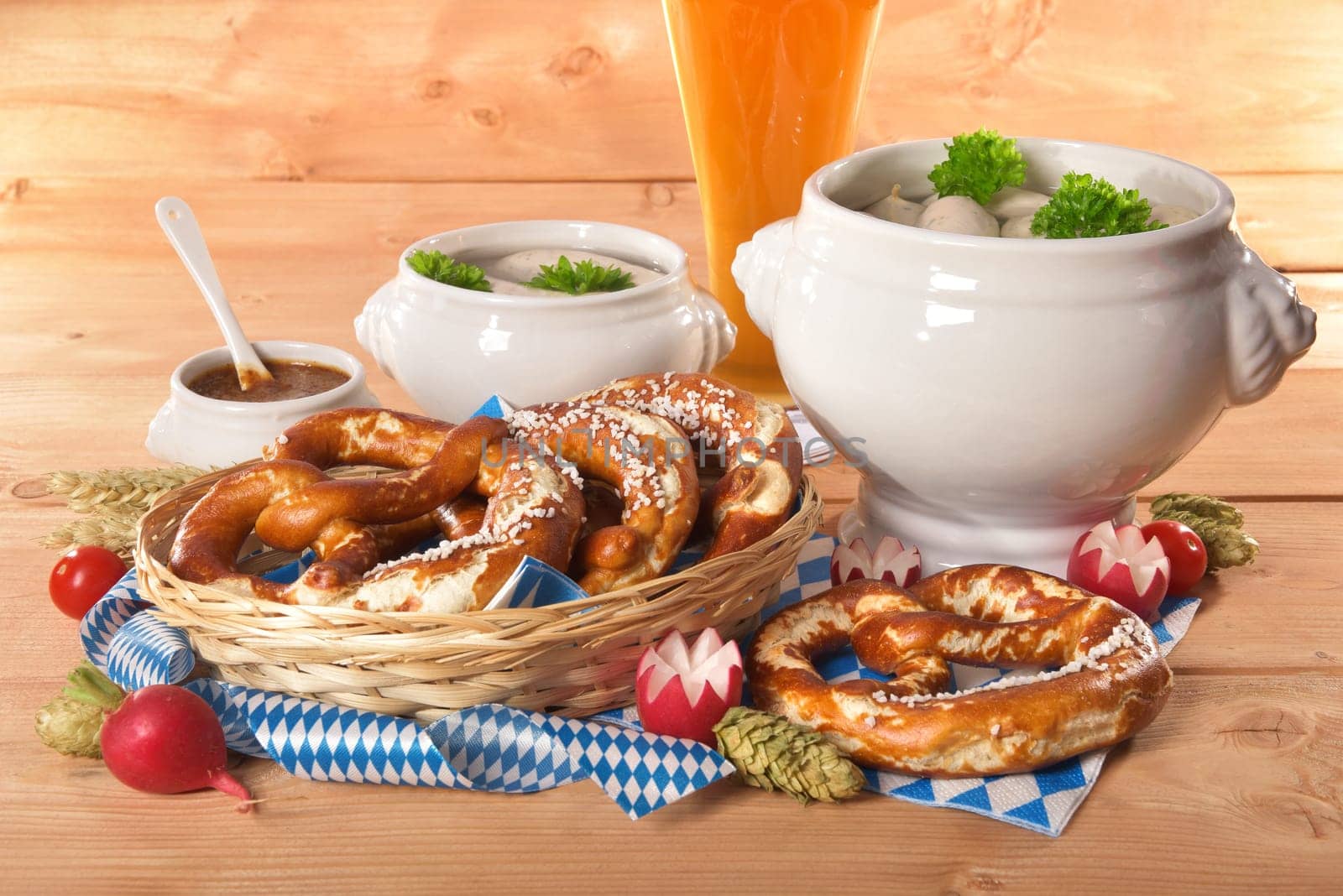 White sausage breakfast with sausages,pretzels,white beer and sweet mustard on wood substrate