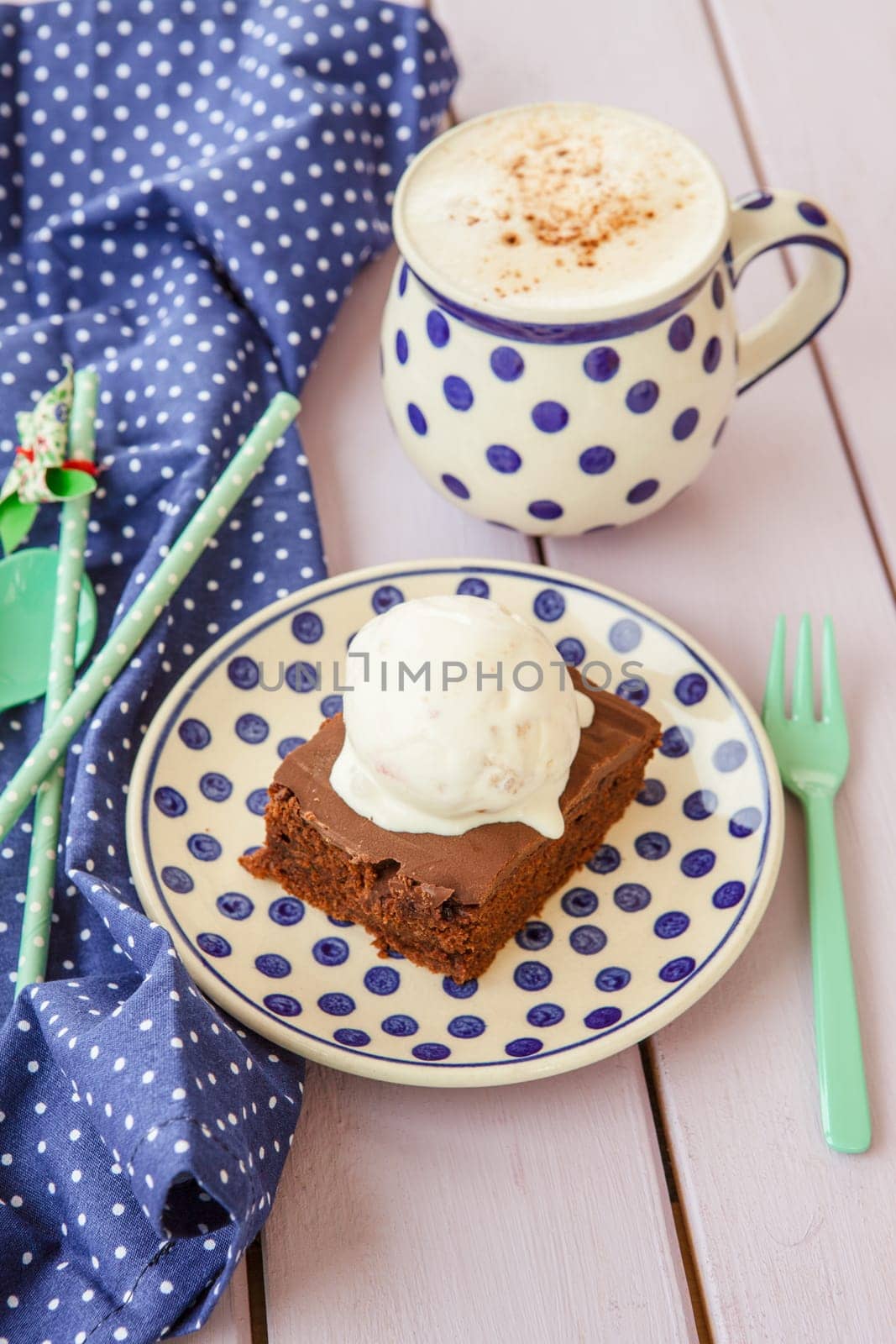 Chocolate cake with ice cream and a cup of cappuccino
