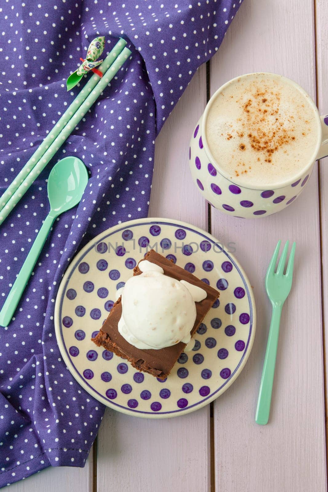 Chocolate cake with ice cream and a cup of cappuccino