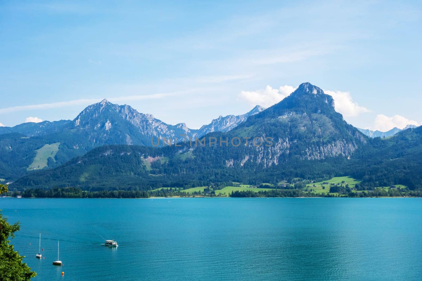 view over the lake Wolfgangsee, Austria, turquoise blue water, mountains in the background