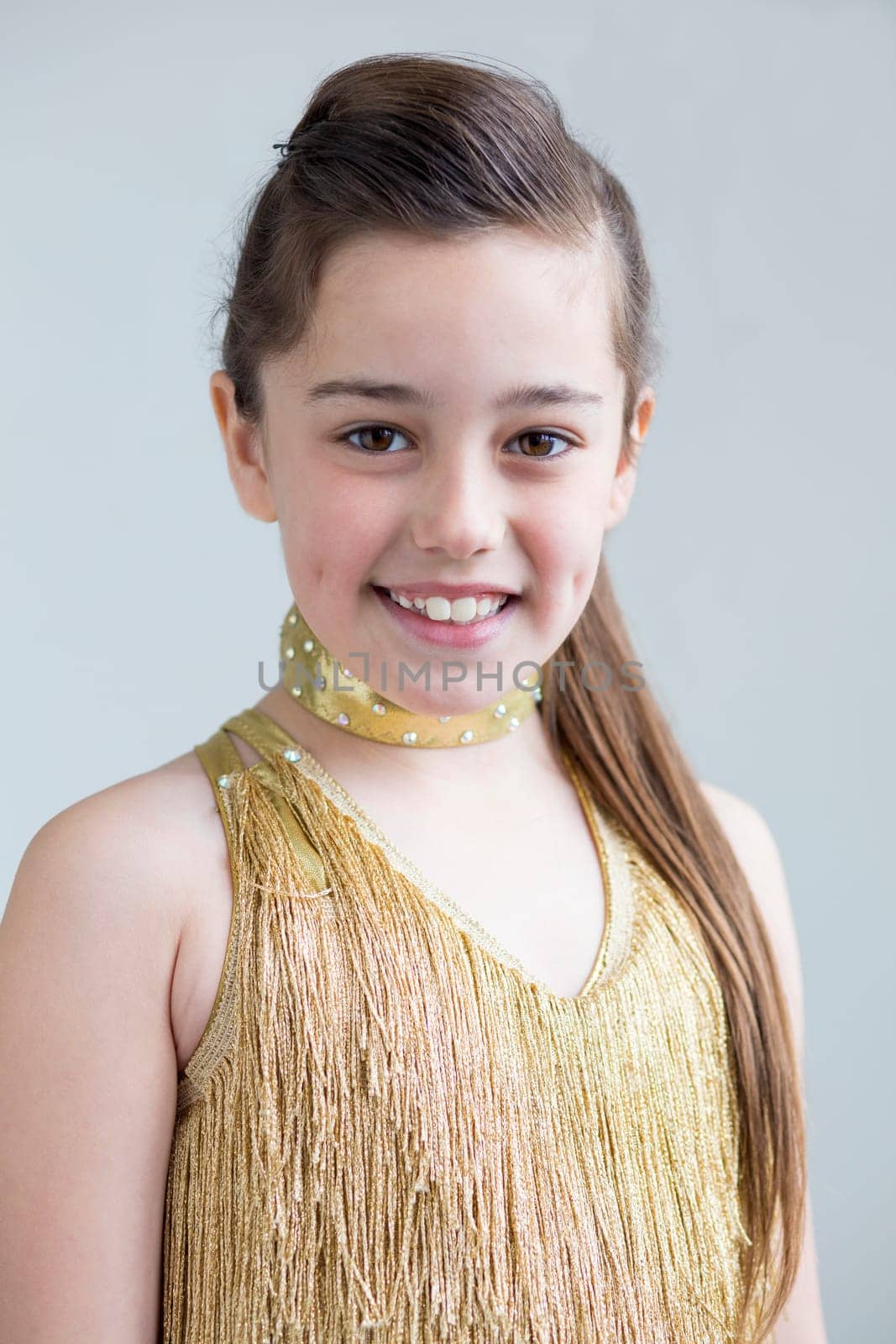 Young girl posing for the camera in her dance costume.