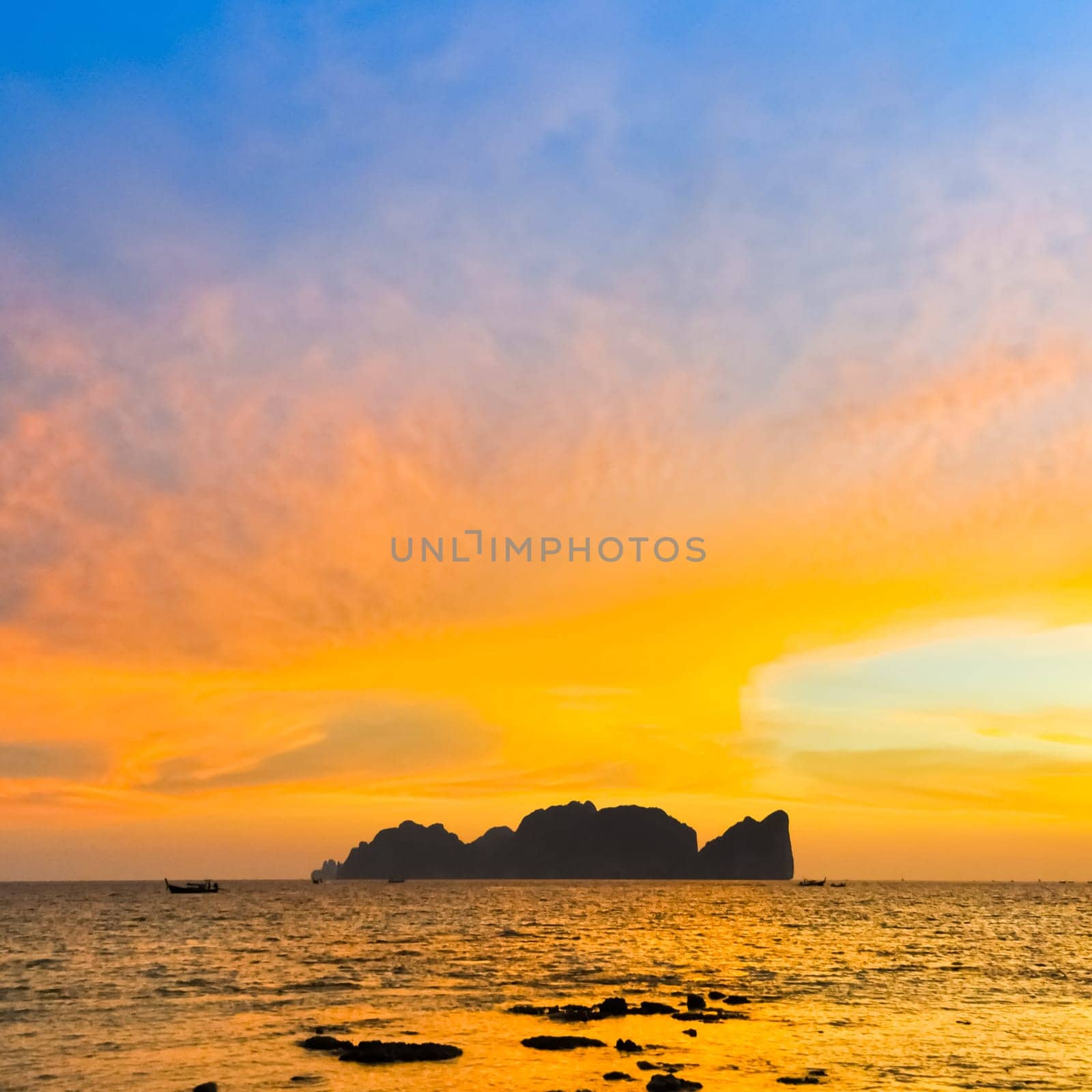 Silhouette of  famous thai Phi-Phi Lee island in colorful romantic sunset. Popular beach holiday travel destination in Thailand, Krabi province.