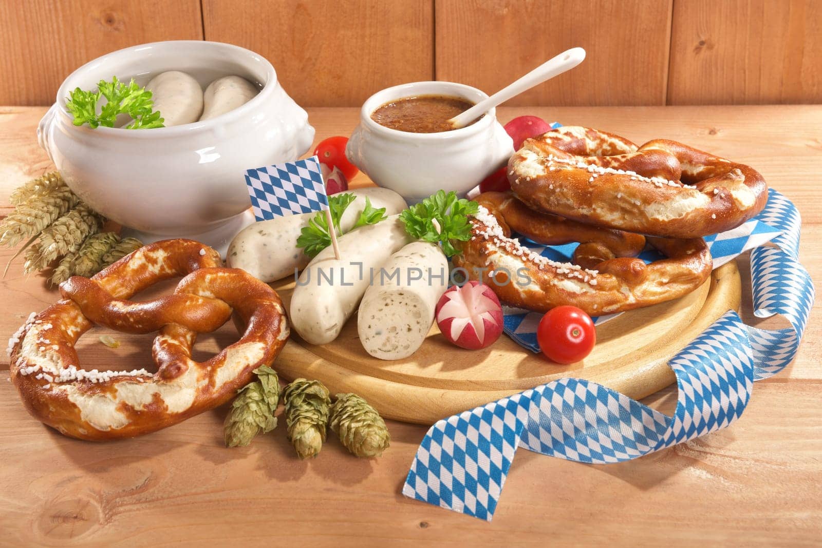 White sausage breakfast with sausages,pretzels and sweet mustard on wood substrate