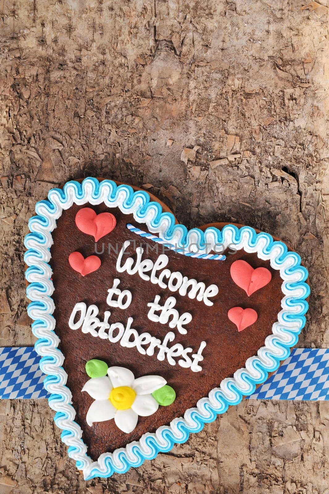original Bavarian Oktoberfest gingerbread heart on real brown tree bark
