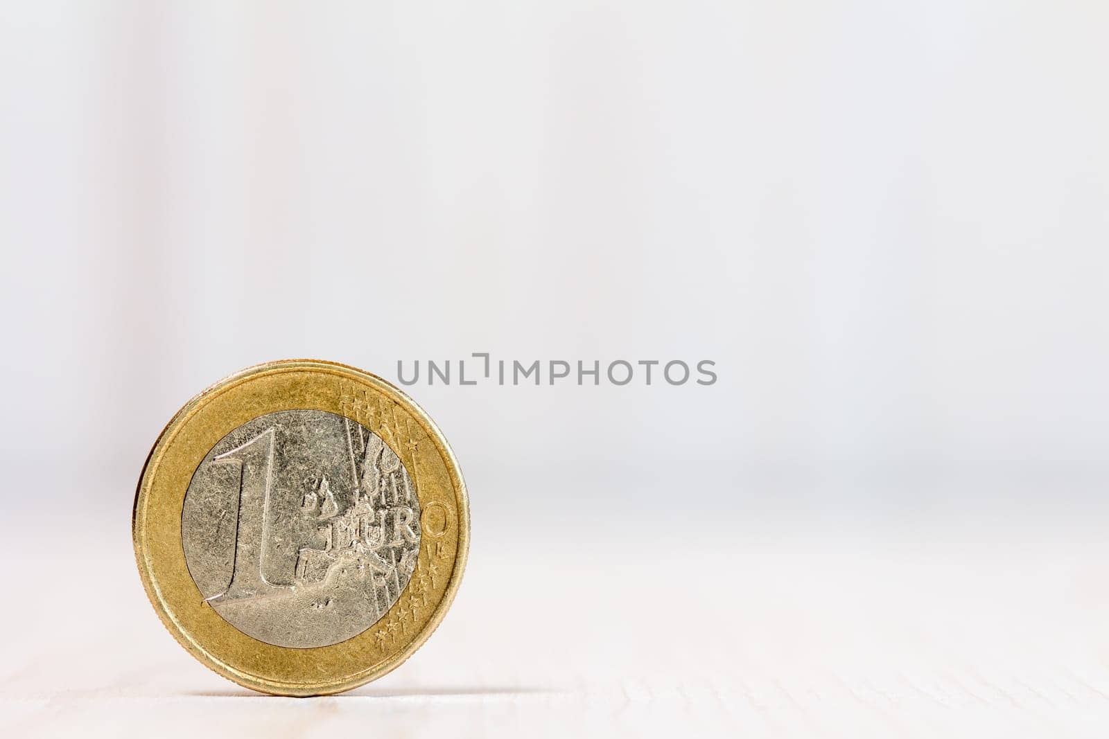 One euro coin on white wood  background. With copy-space for text