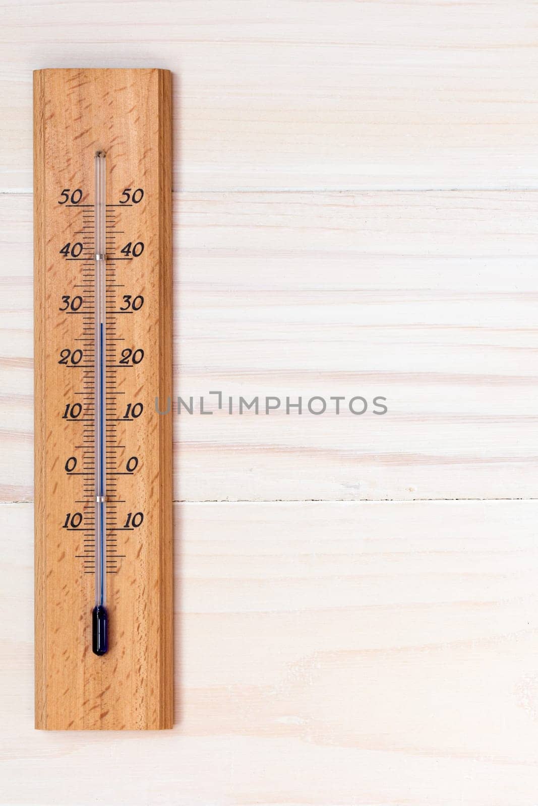 Thermometer on wooden background with copy-space for text