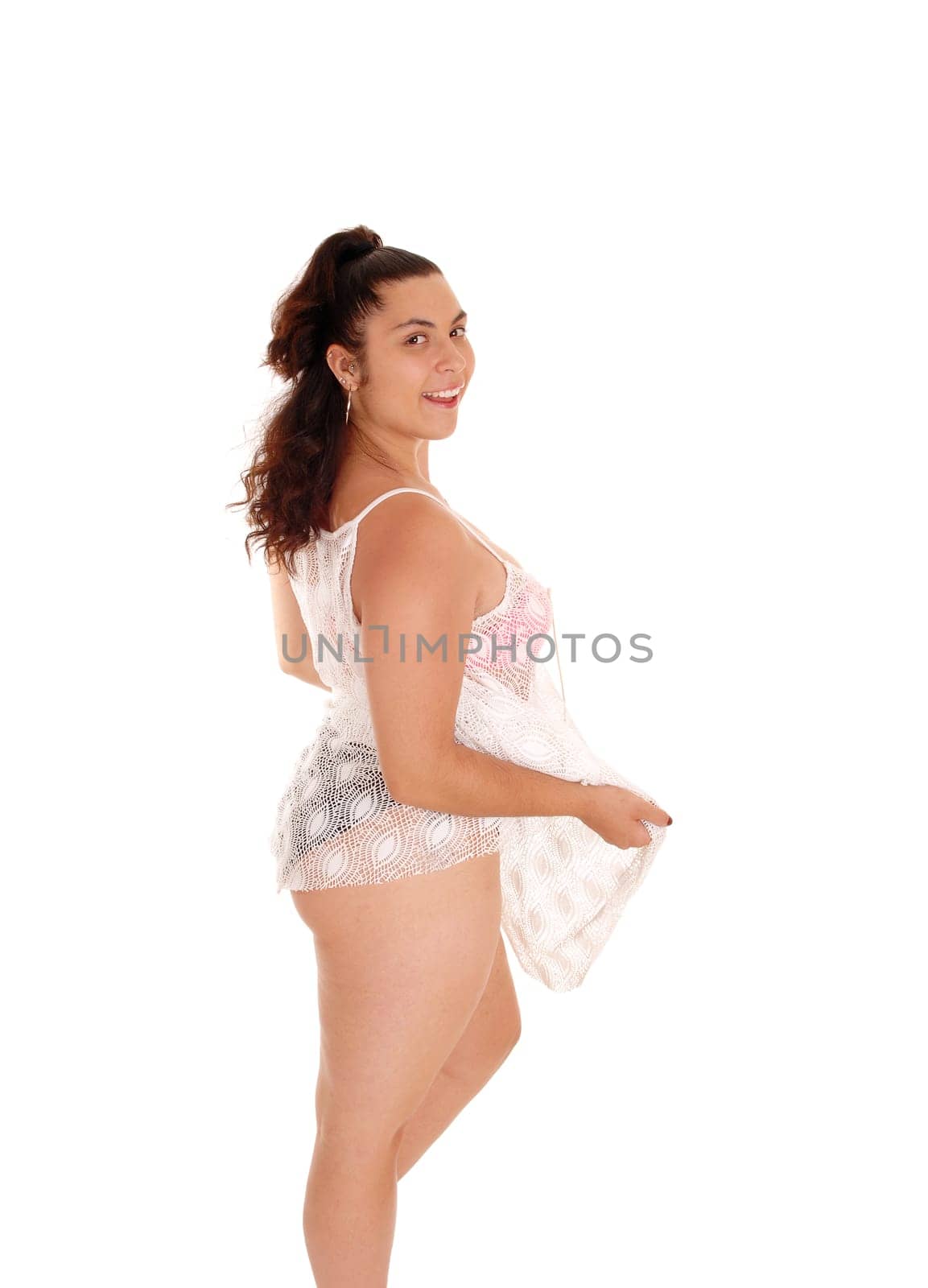A happy young woman in a pink bikini top and black panties standing in.profile isolated in profile for white background..