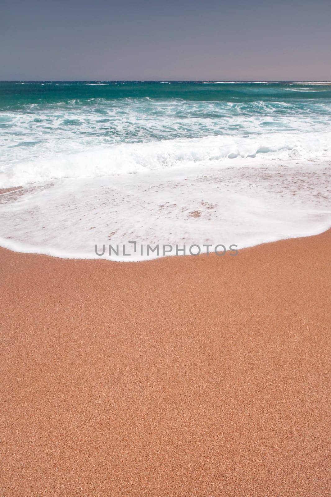 Sea wave and sand on the beach.
