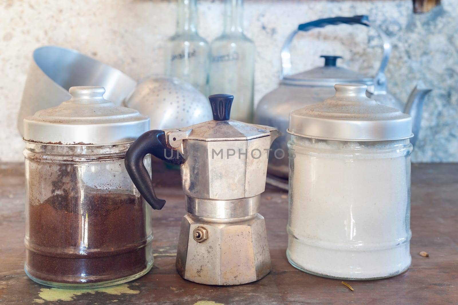Old coffee maker with two old cans for sugar and coffee