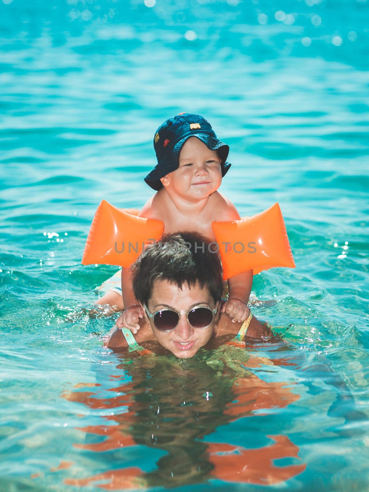 Baby and mother in a sea